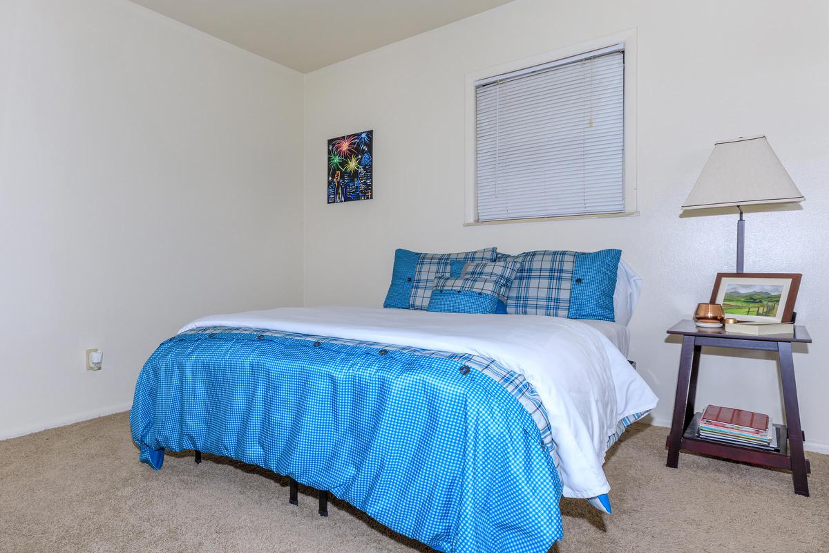 a blue and white bed in a room