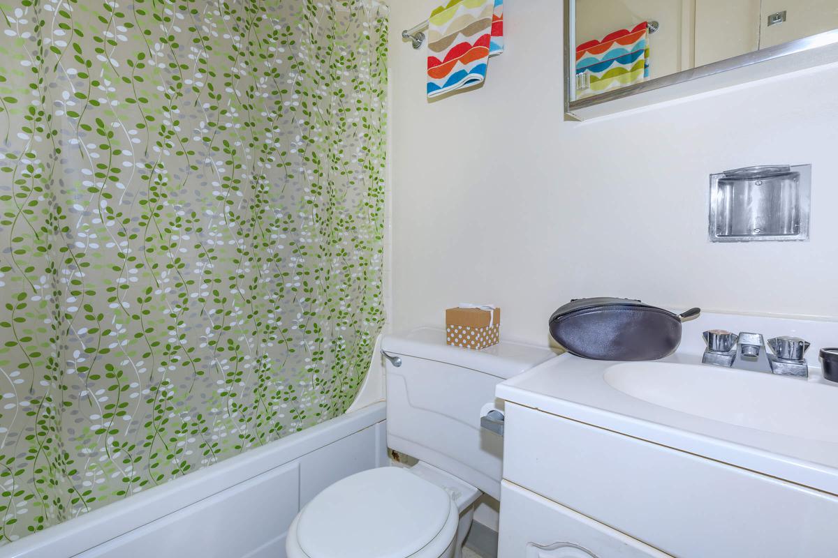 a white tub sitting next to a shower