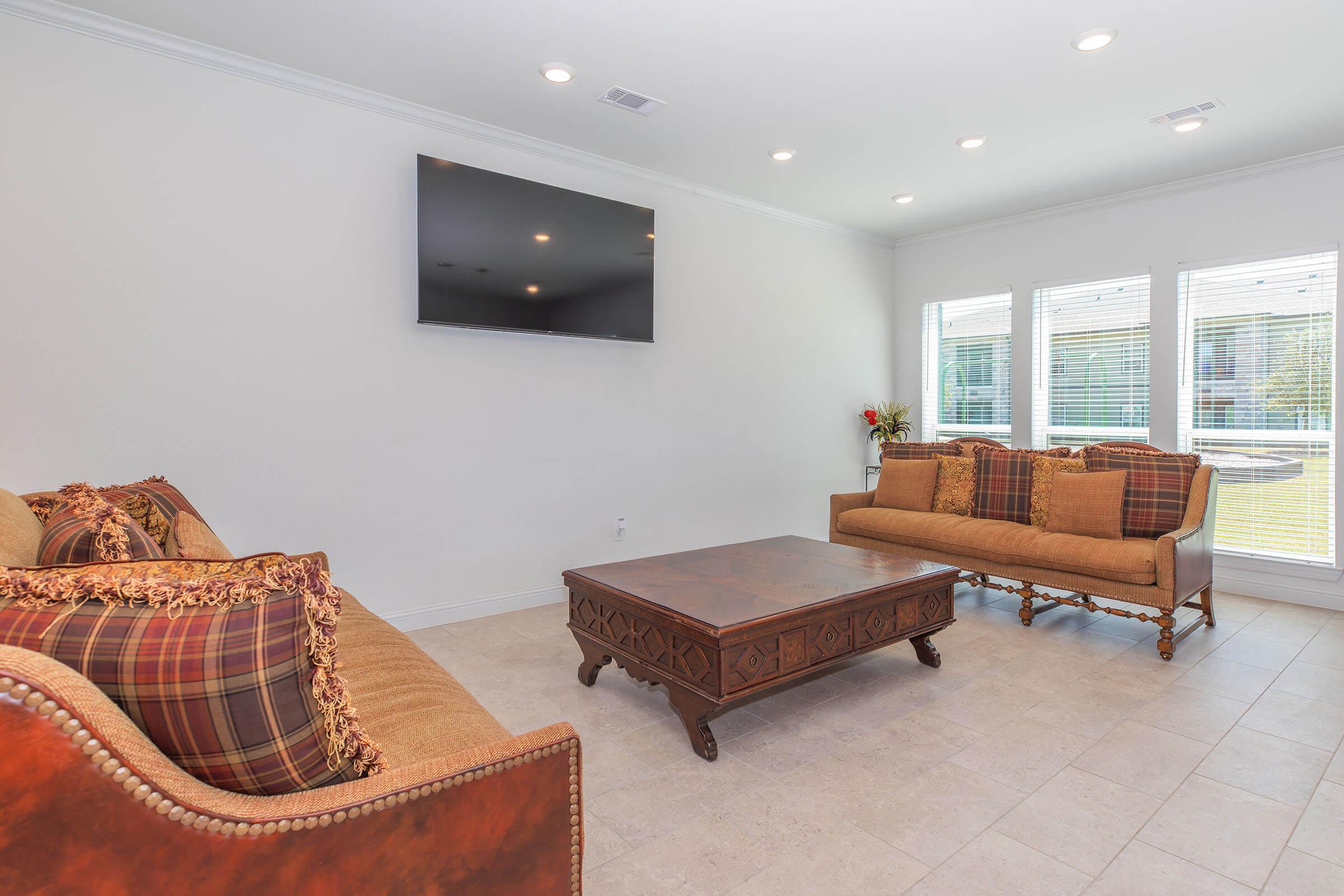 a living room filled with furniture and a large window