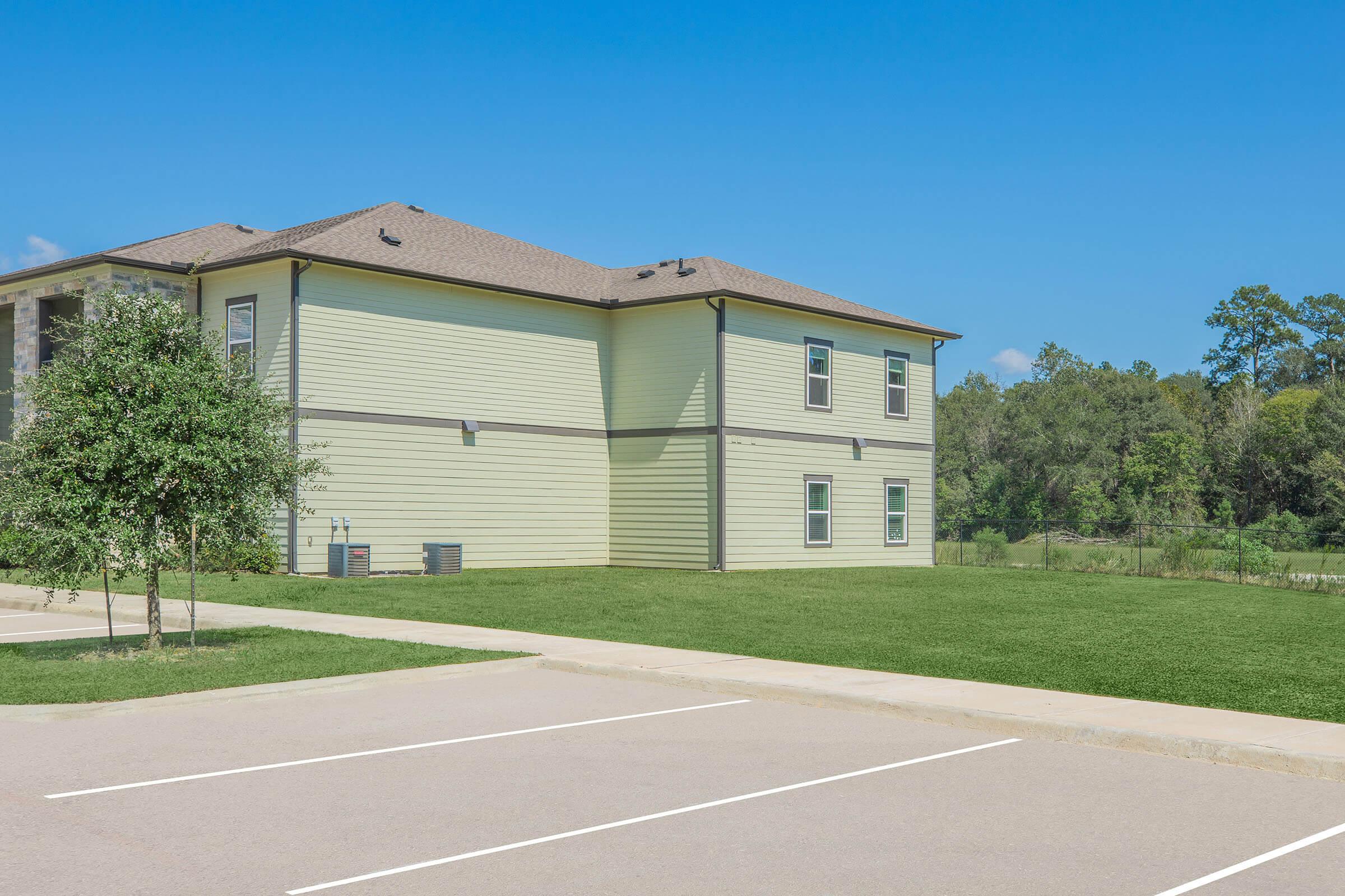 a house that has a sign on the side of a road