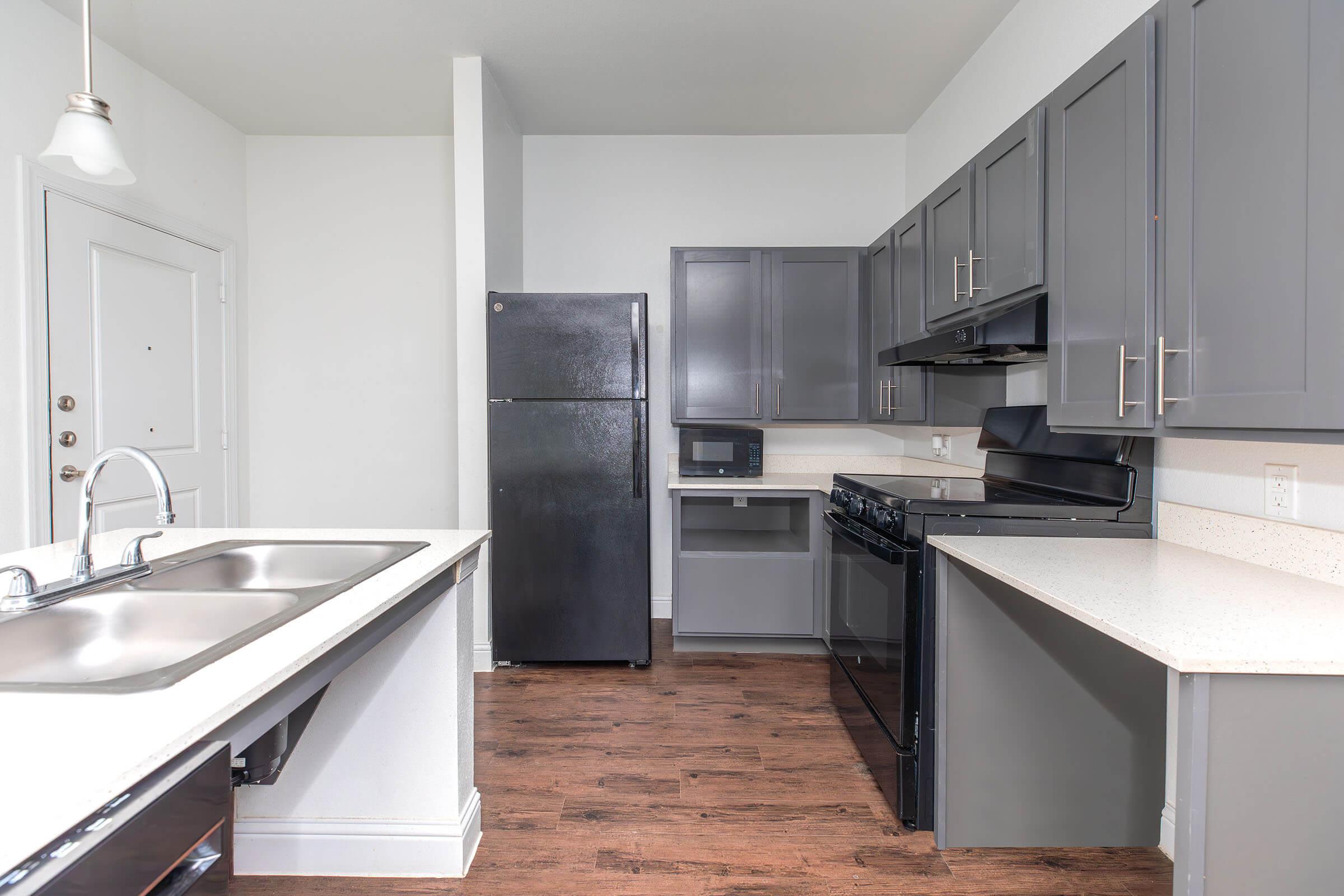 a kitchen with a sink and a microwave