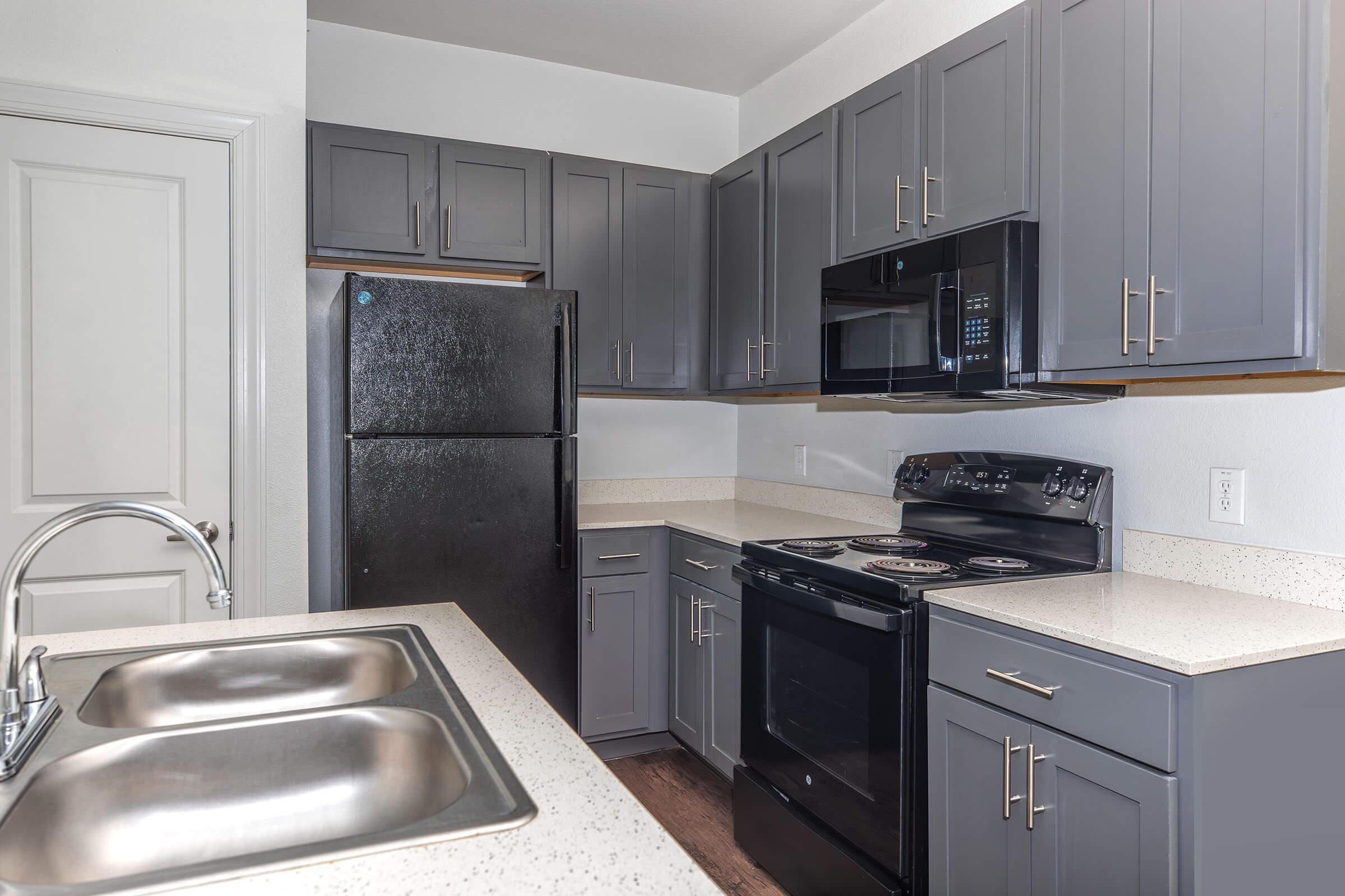 a kitchen with a sink and a microwave