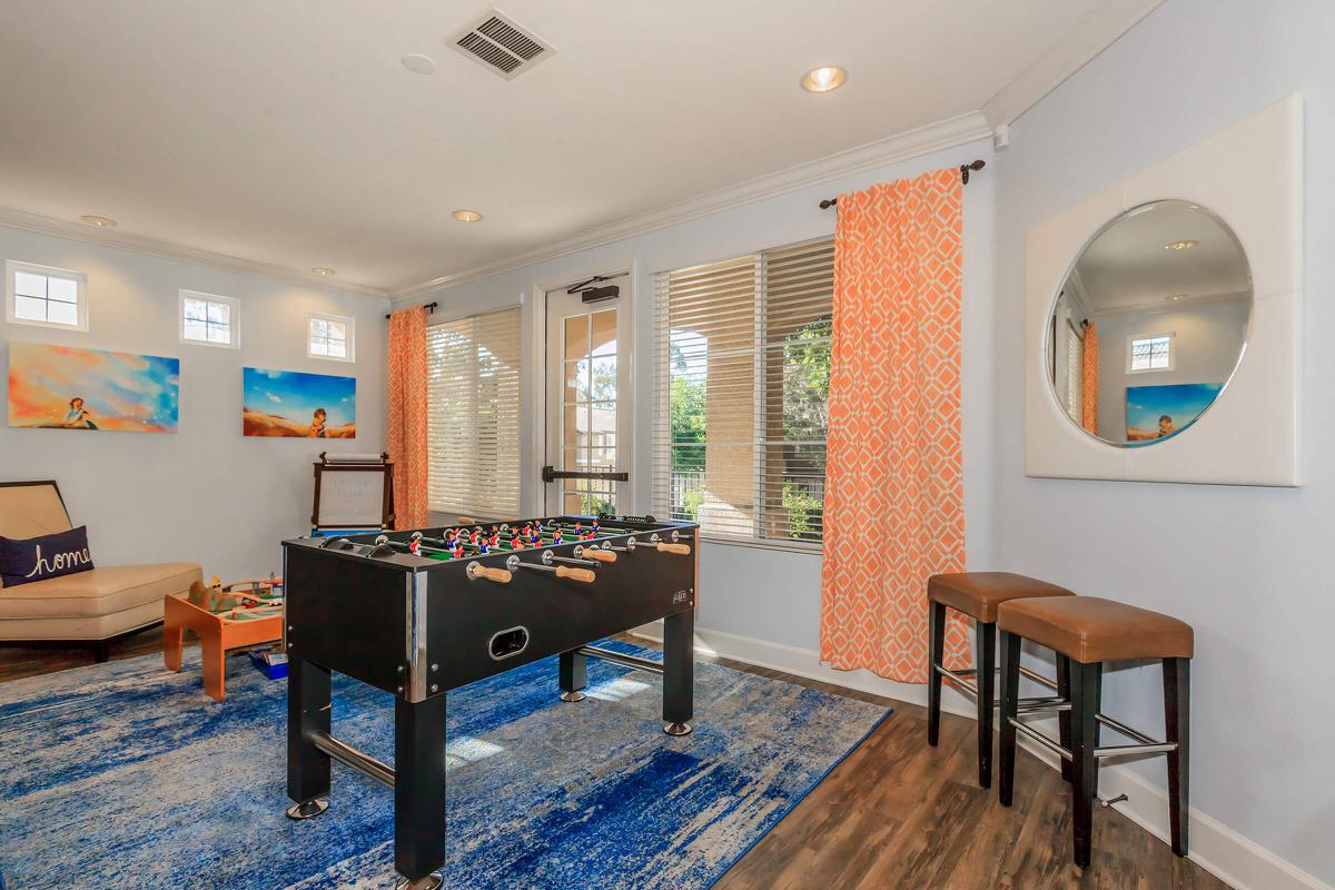 a living room filled with furniture and a flat screen tv