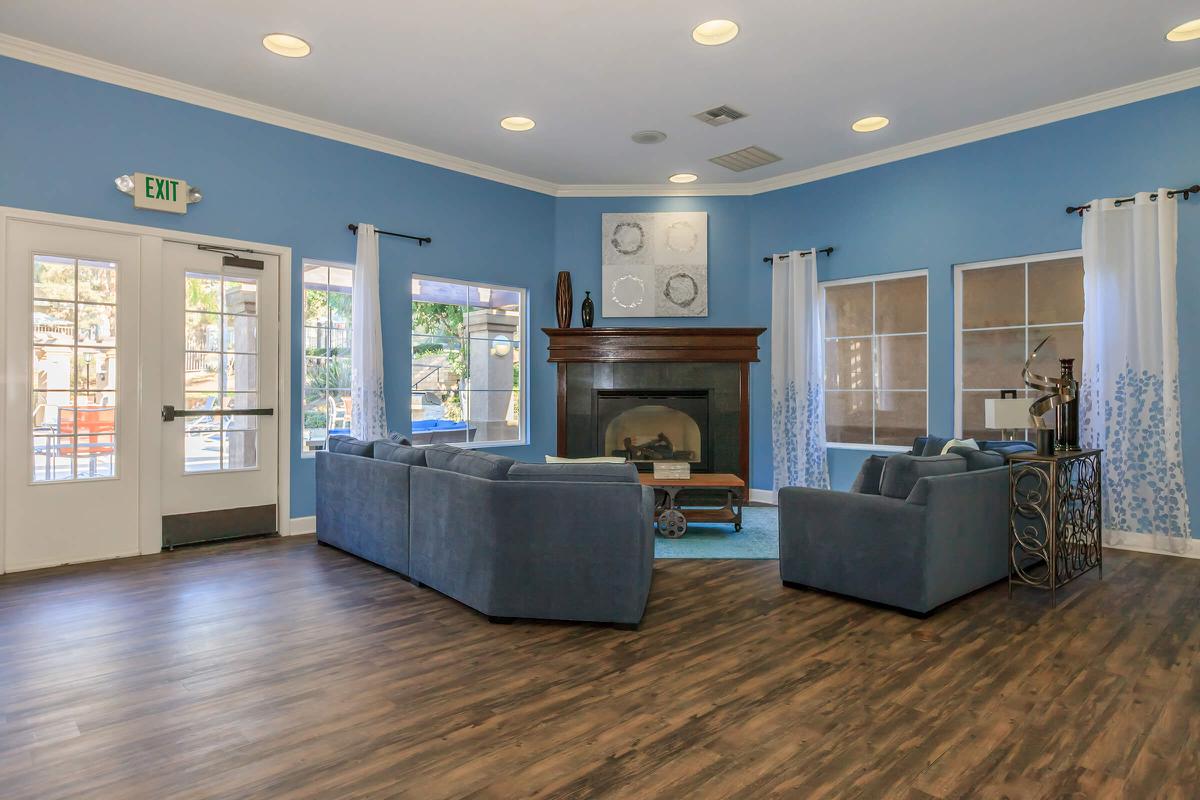 a living room filled with furniture and a large window