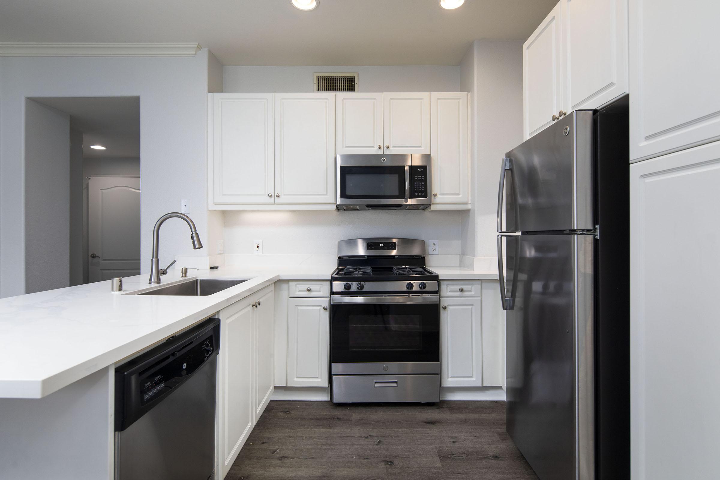 a kitchen with a stove and a refrigerator