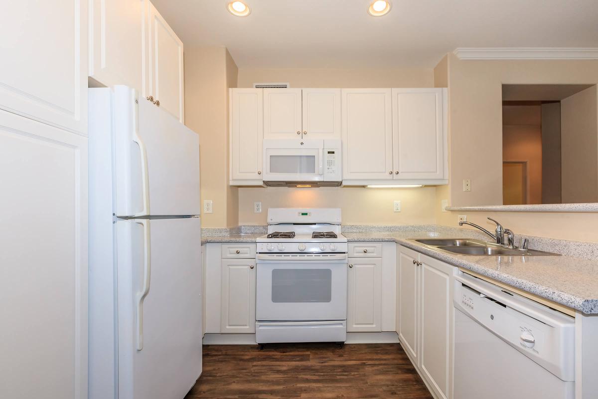 a kitchen with a white stove top oven sitting inside of a refrigerator