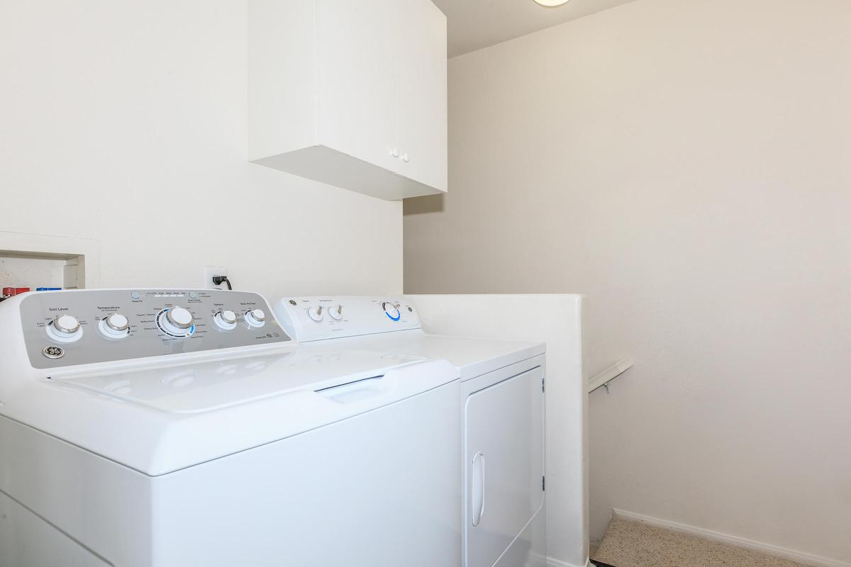 a white refrigerator freezer sitting next to a sink