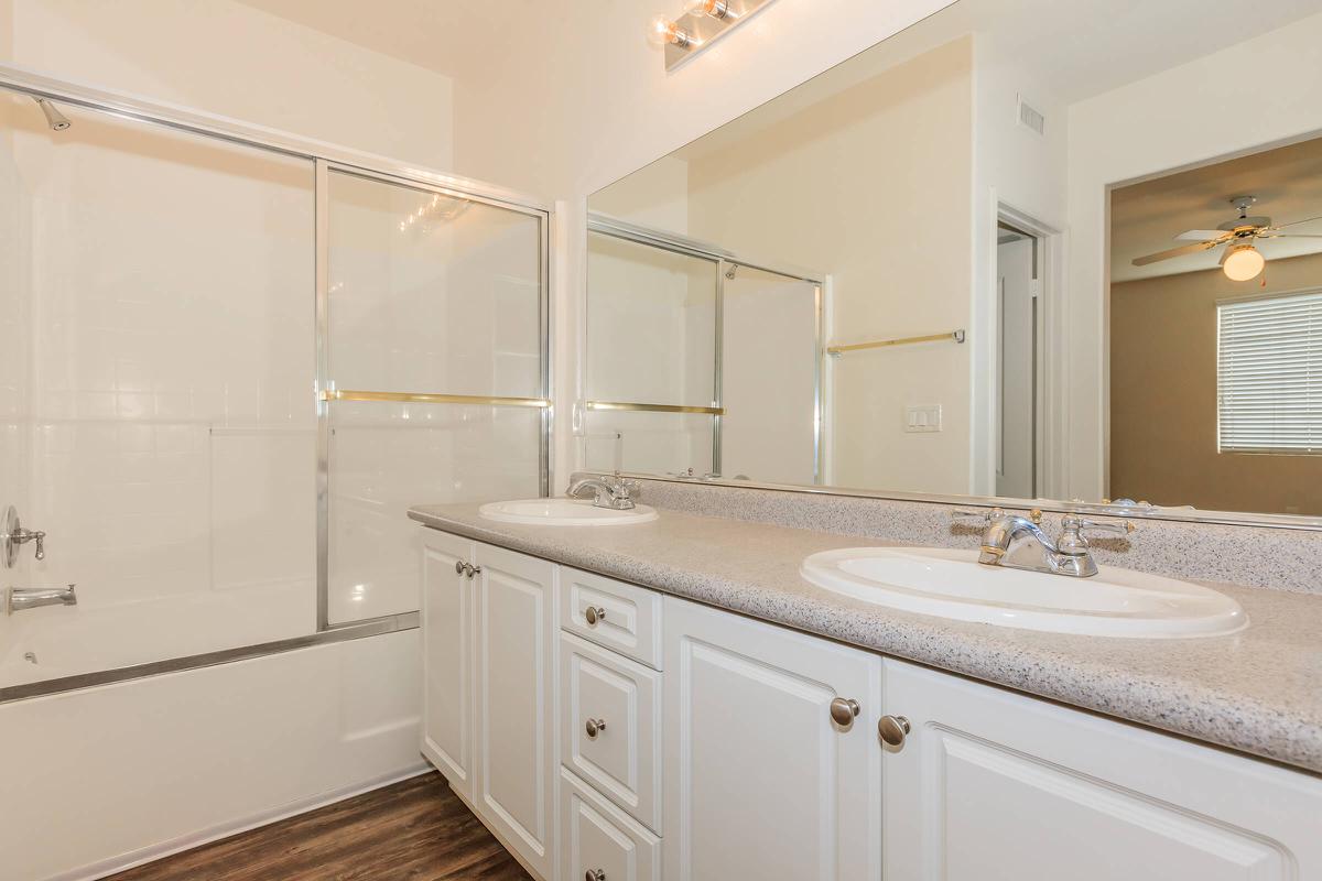 a white sink sitting under a window