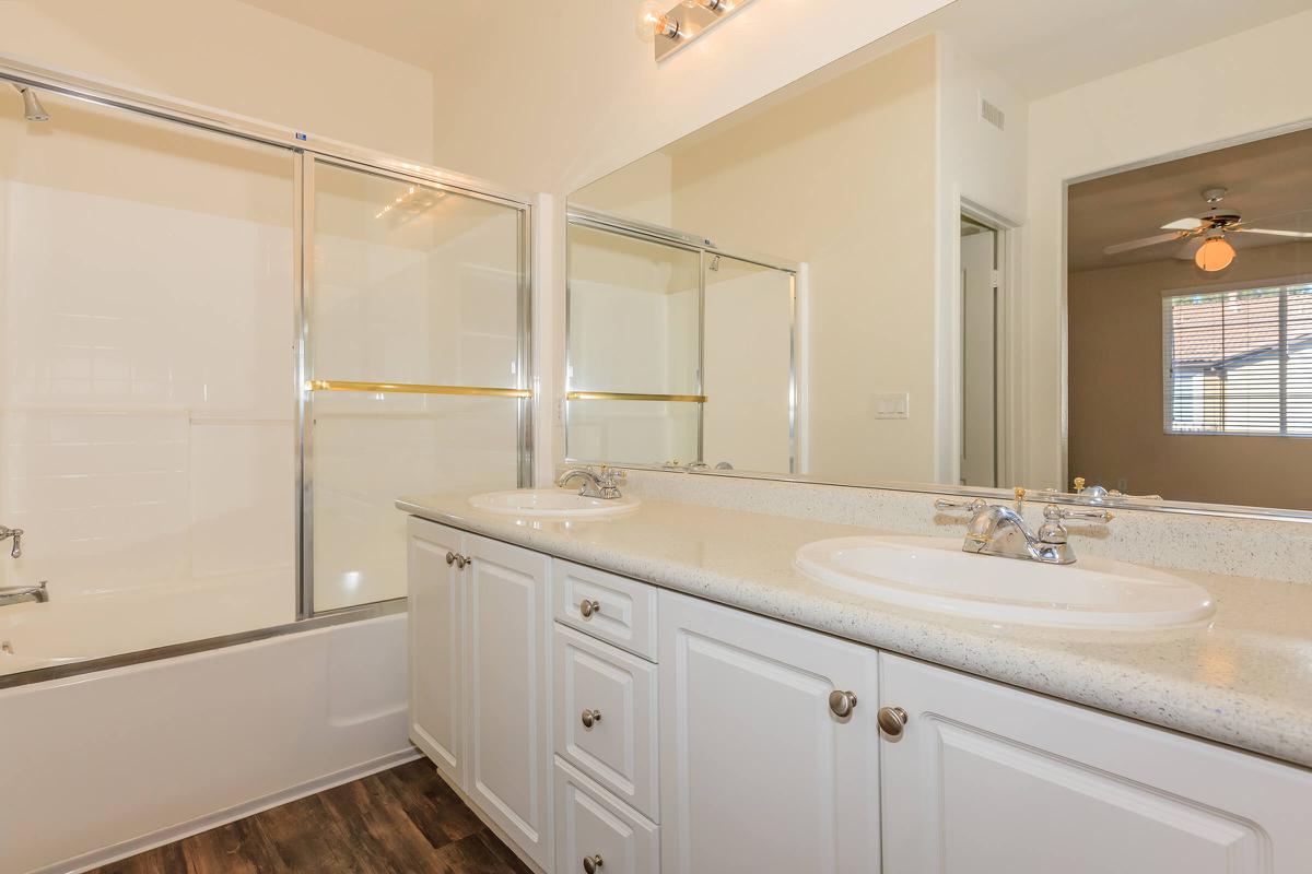 a large white tub next to a sink