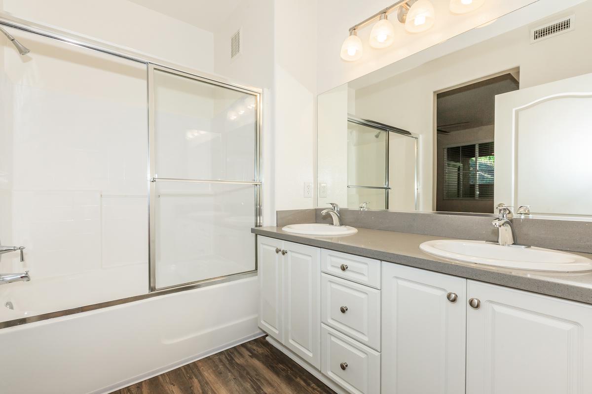 a white sink sitting under a window