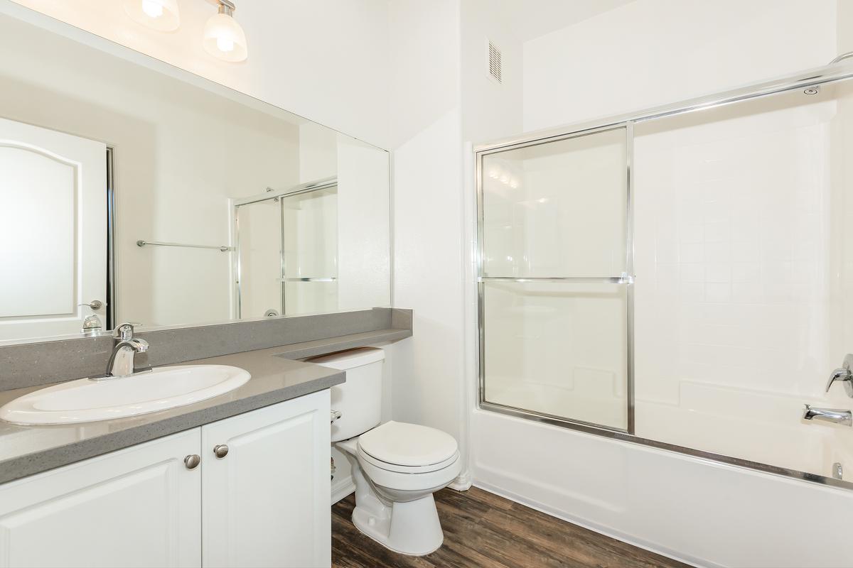 a white tub sitting next to a sink