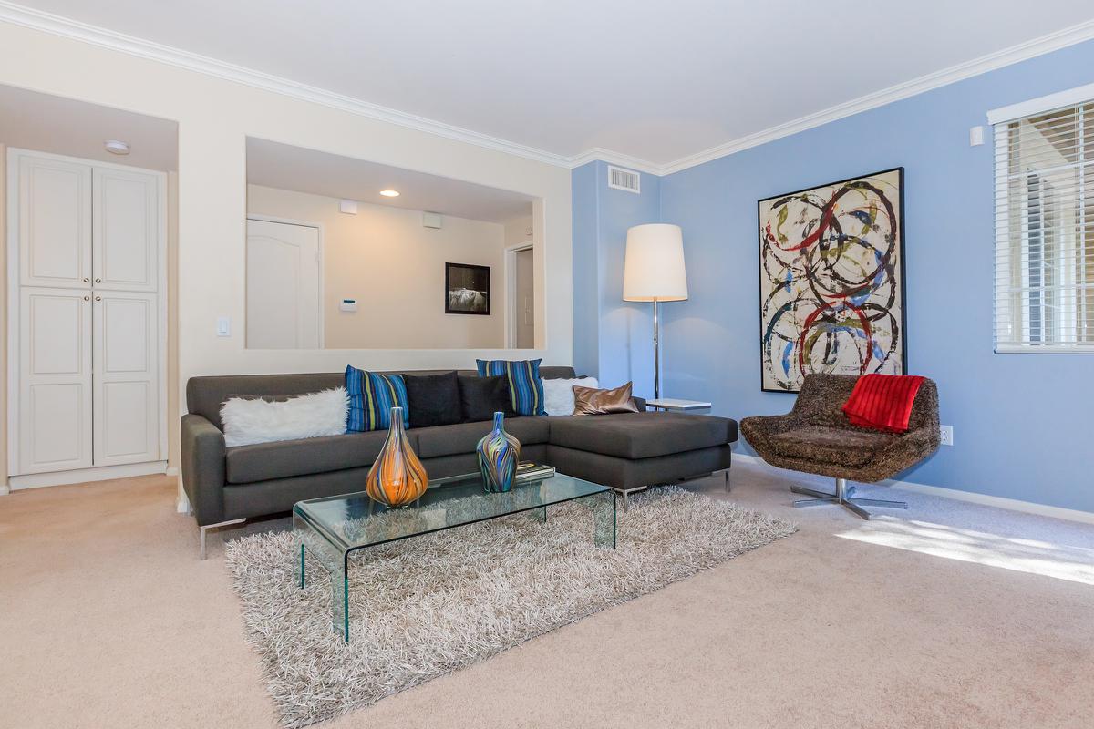 a living room filled with furniture and a flat screen tv