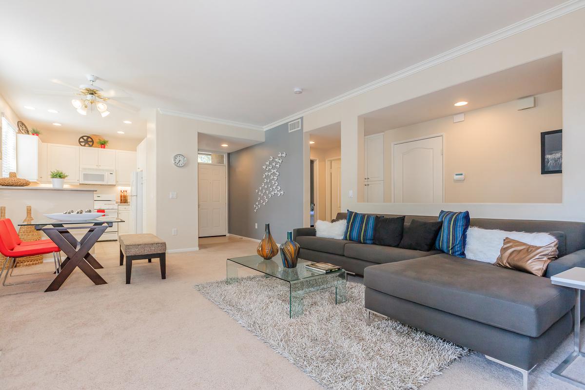 a living room filled with furniture and a flat screen tv