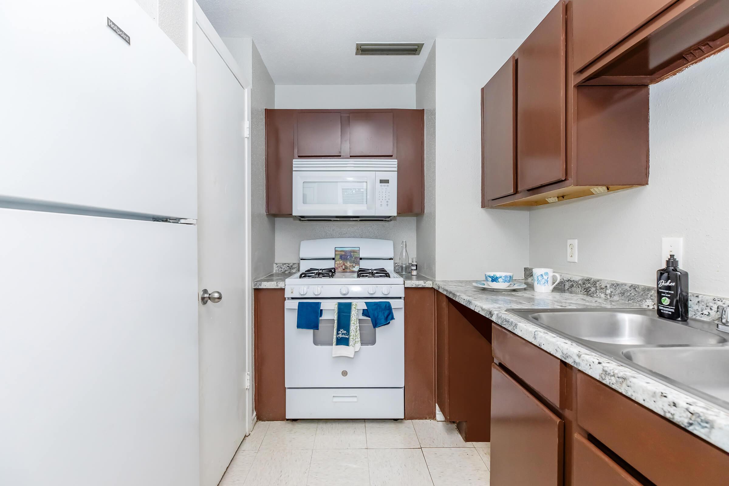 a kitchen with a stove sink and refrigerator