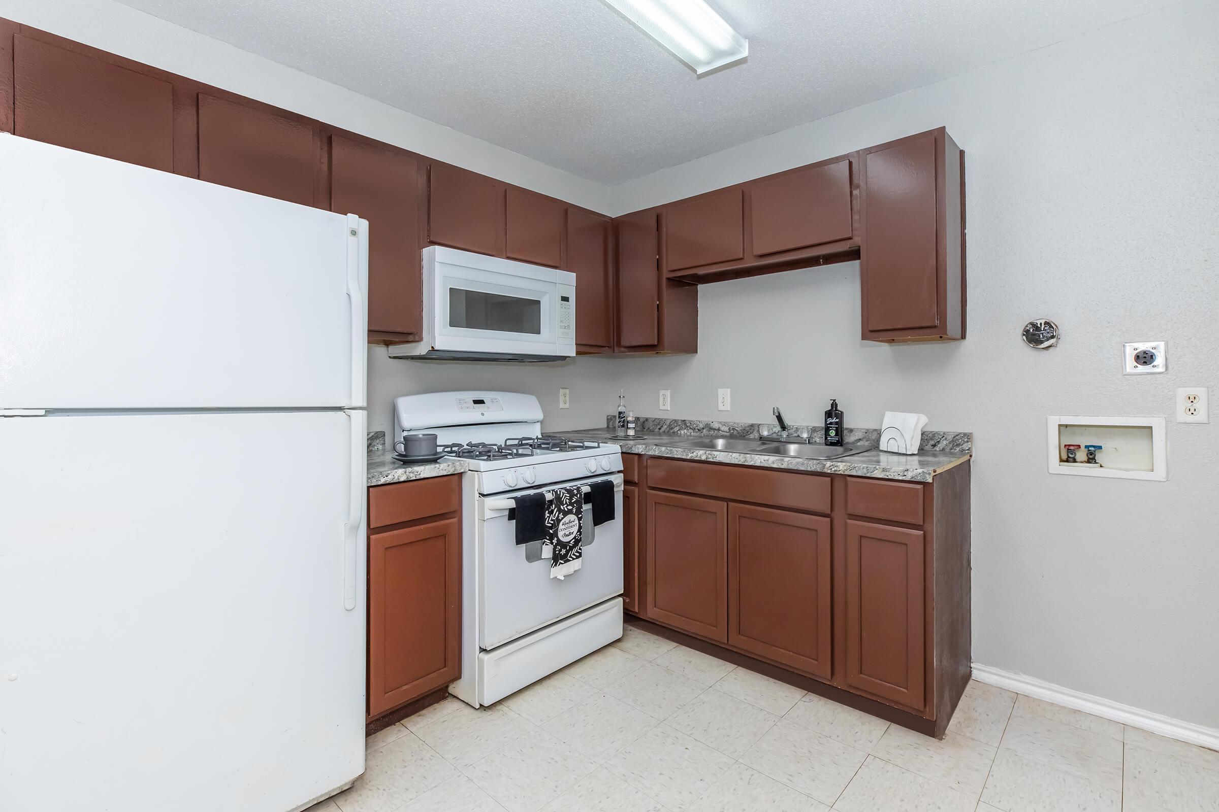 a kitchen with a stove and a refrigerator