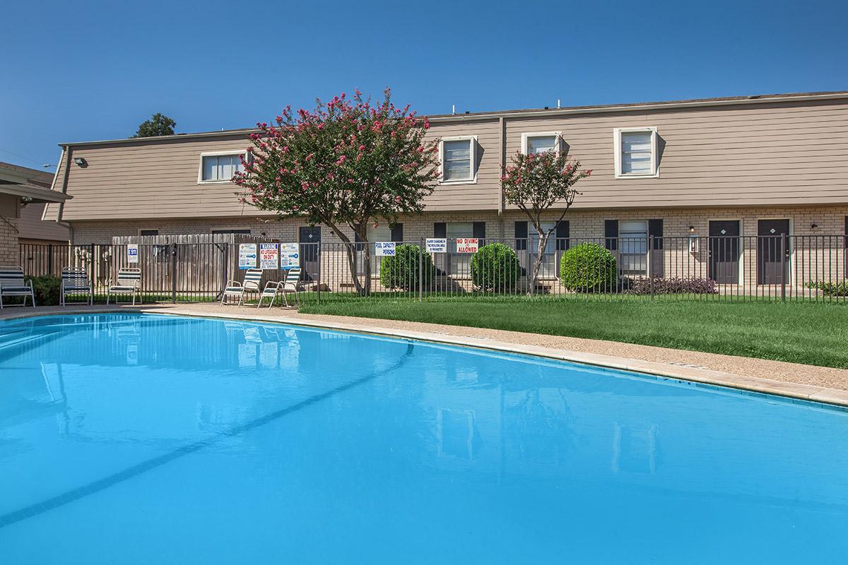 a house with a pool in front of a building