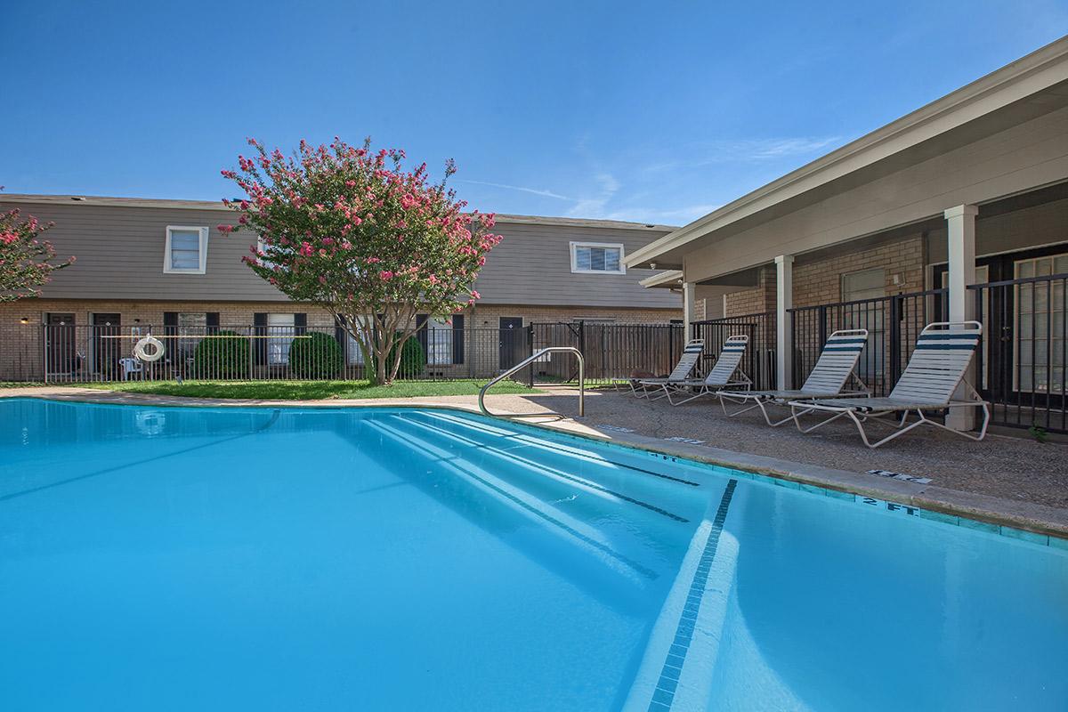 a blue pool of water in front of a building