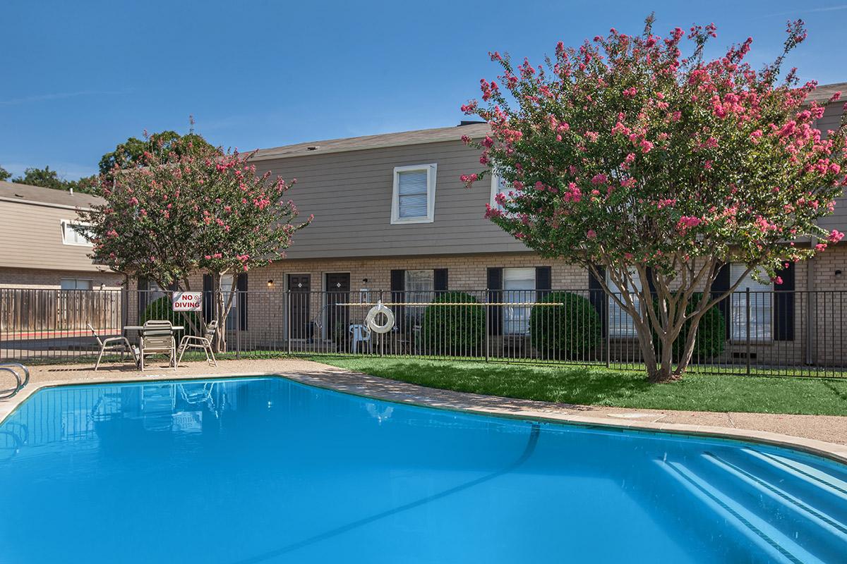 a house with a pool in front of a building