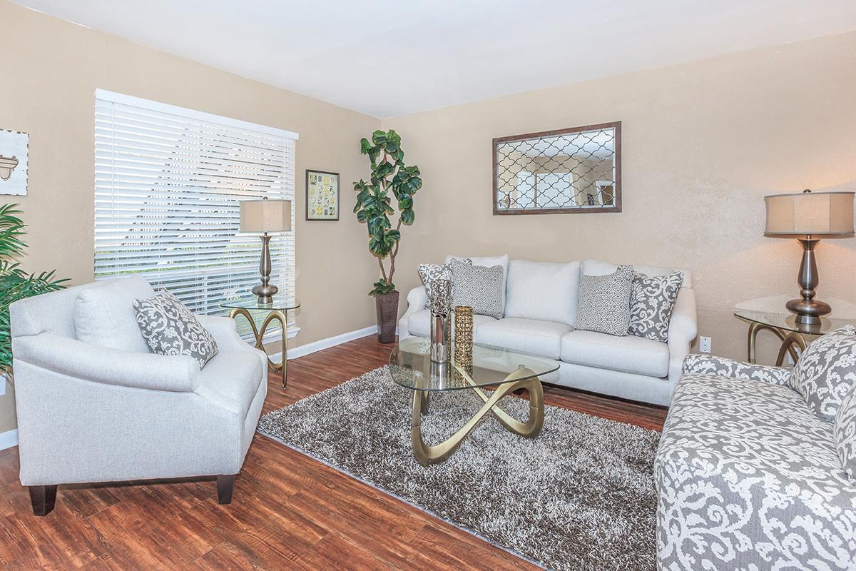 a living room filled with furniture and a flat screen tv