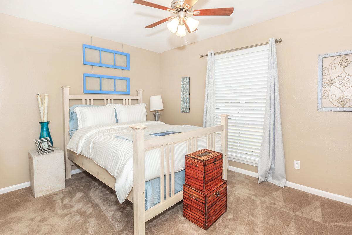 a bedroom with a bed and desk in a room