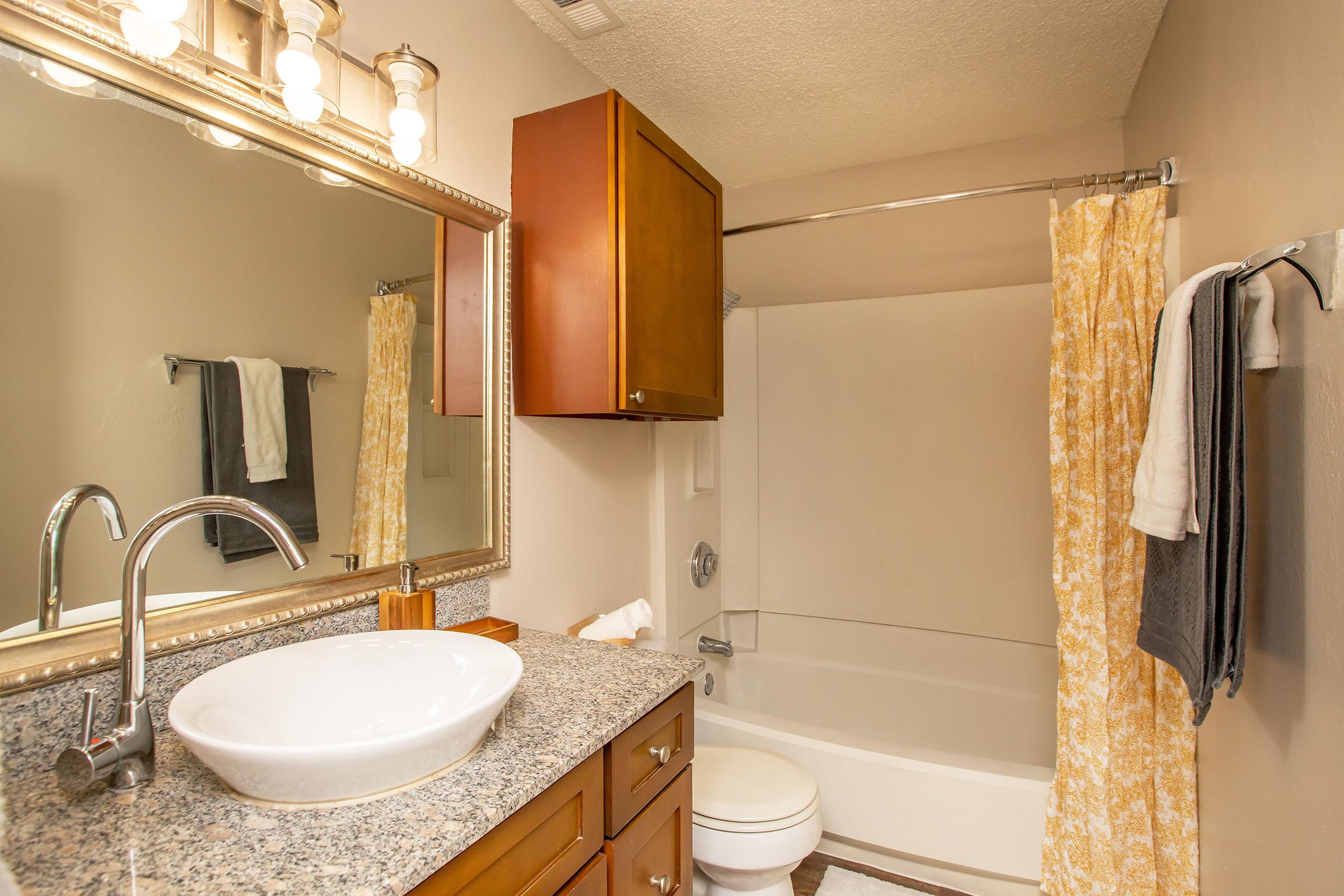 a kitchen with a sink and a mirror