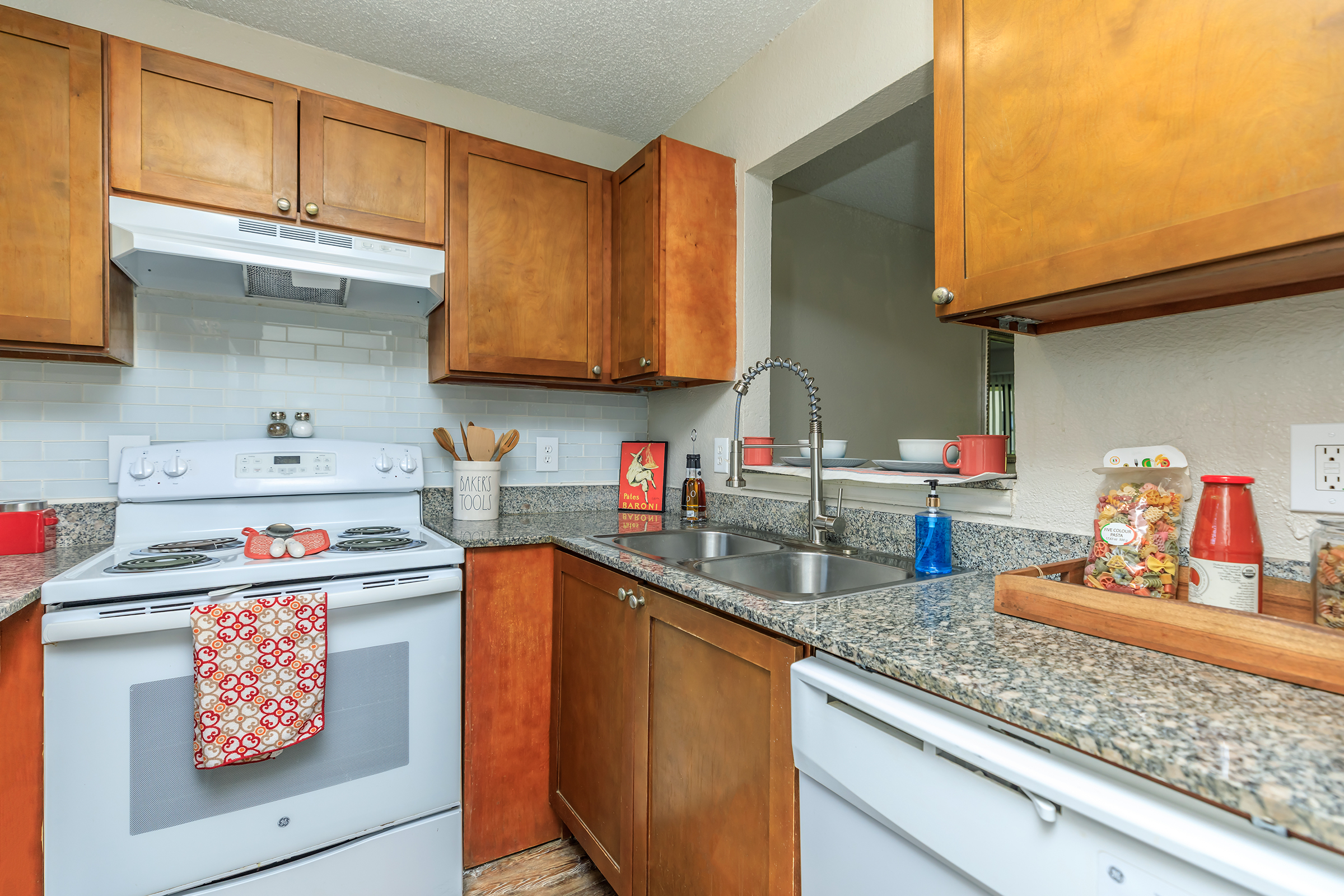 a kitchen with stainless steel appliances and wooden cabinets