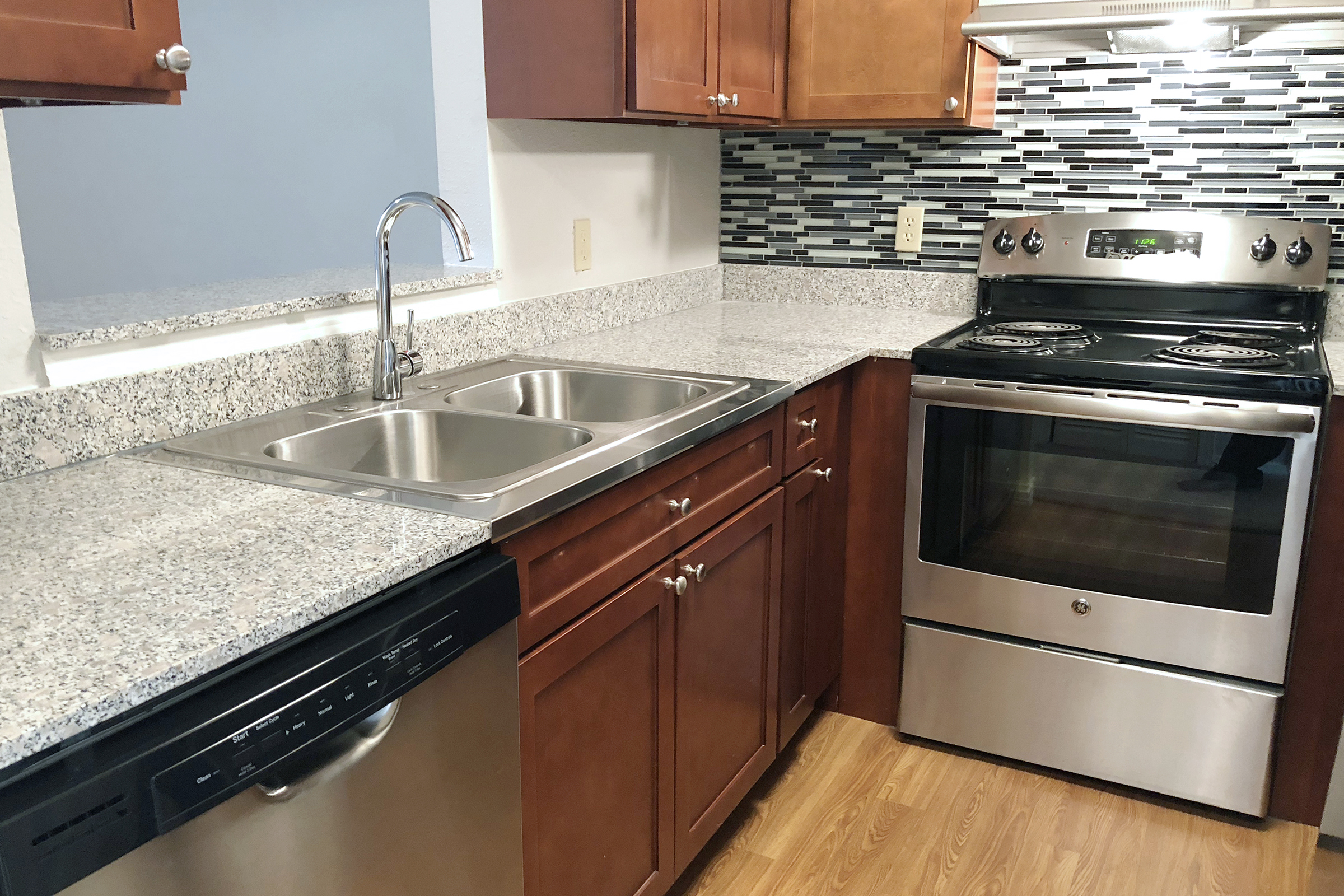 a kitchen with stainless steel appliances and wooden cabinets