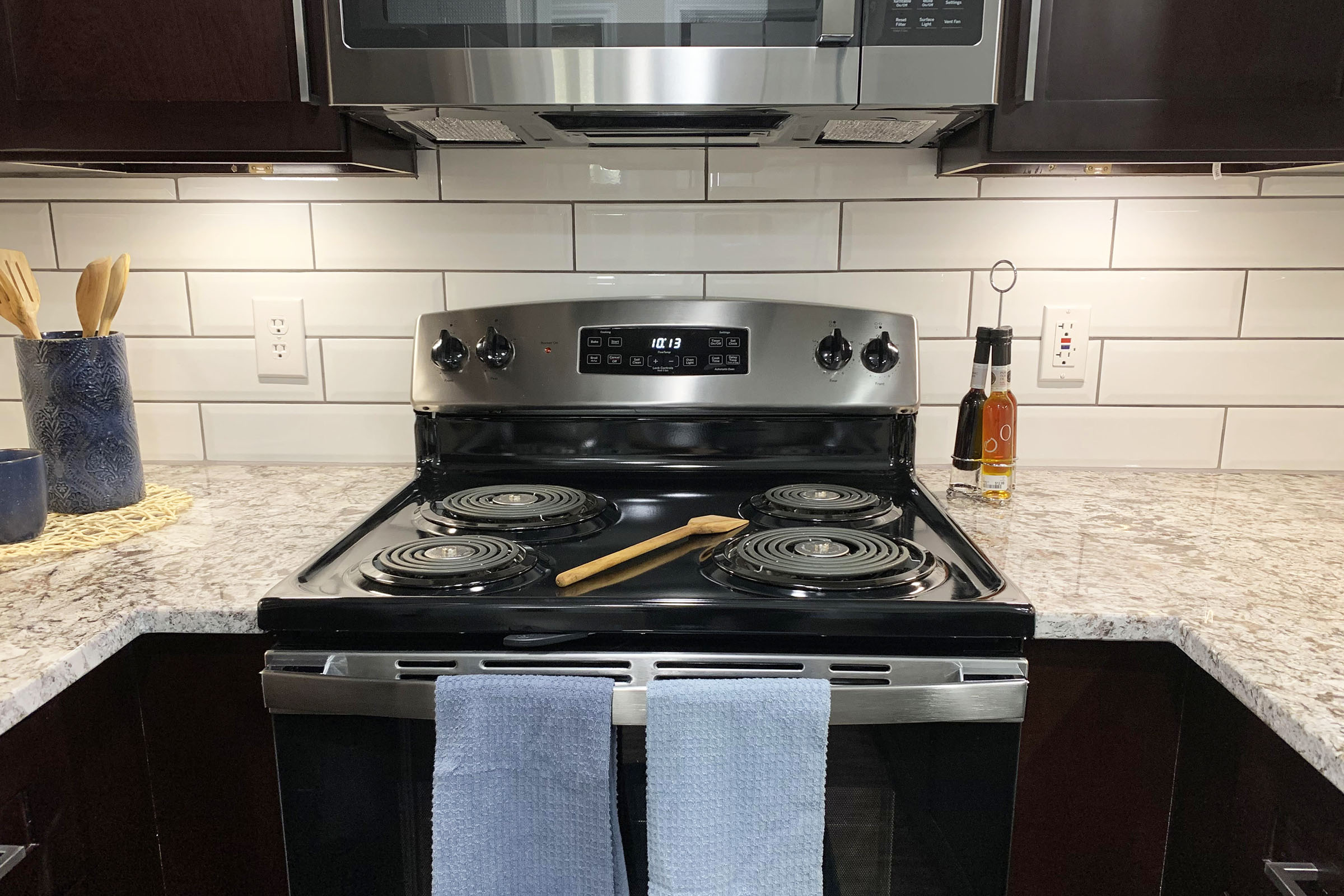 a stove top oven sitting inside of a kitchen