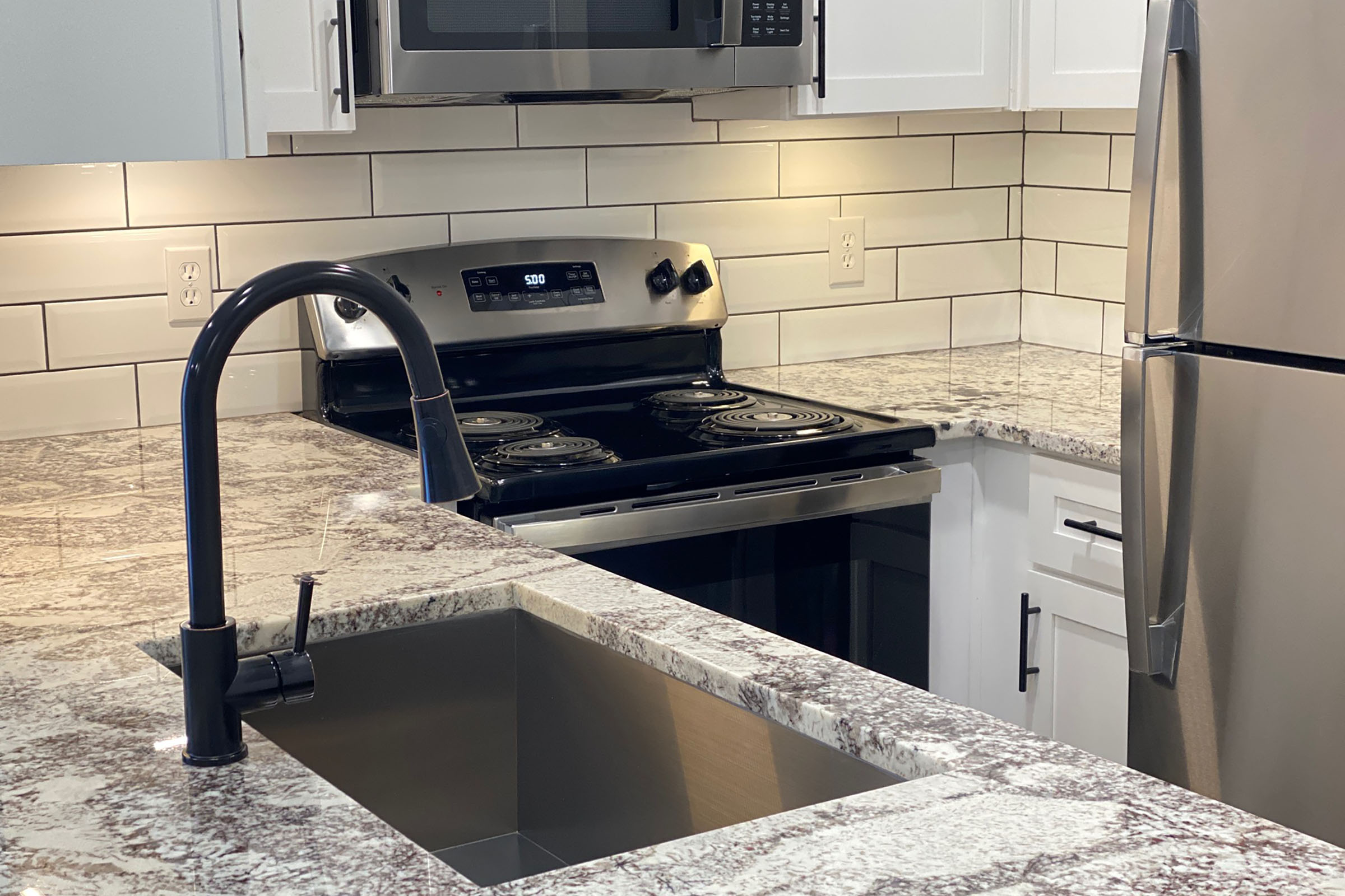 a stove top oven sitting inside of a kitchen