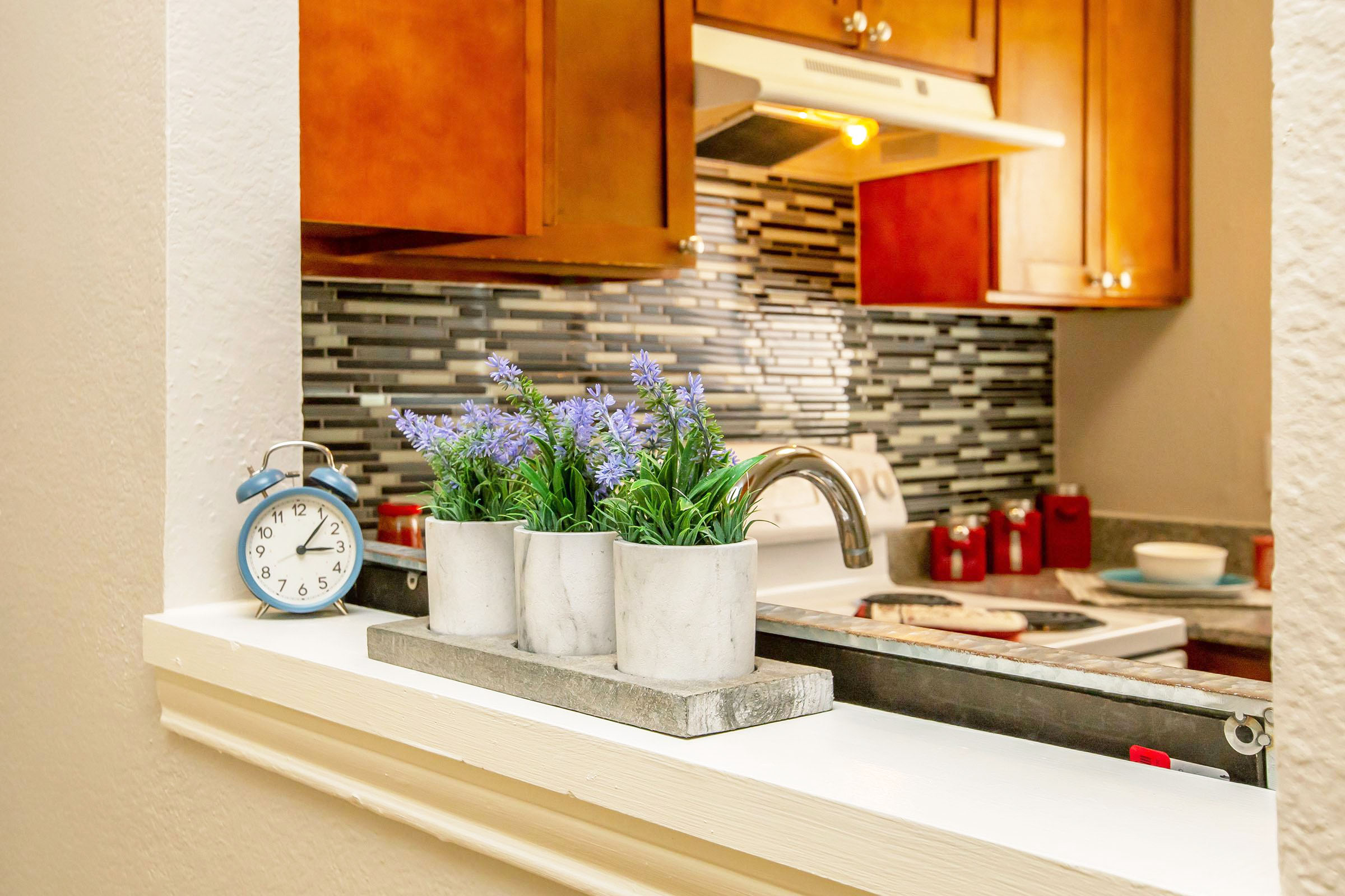 a kitchen with a sink and a mirror