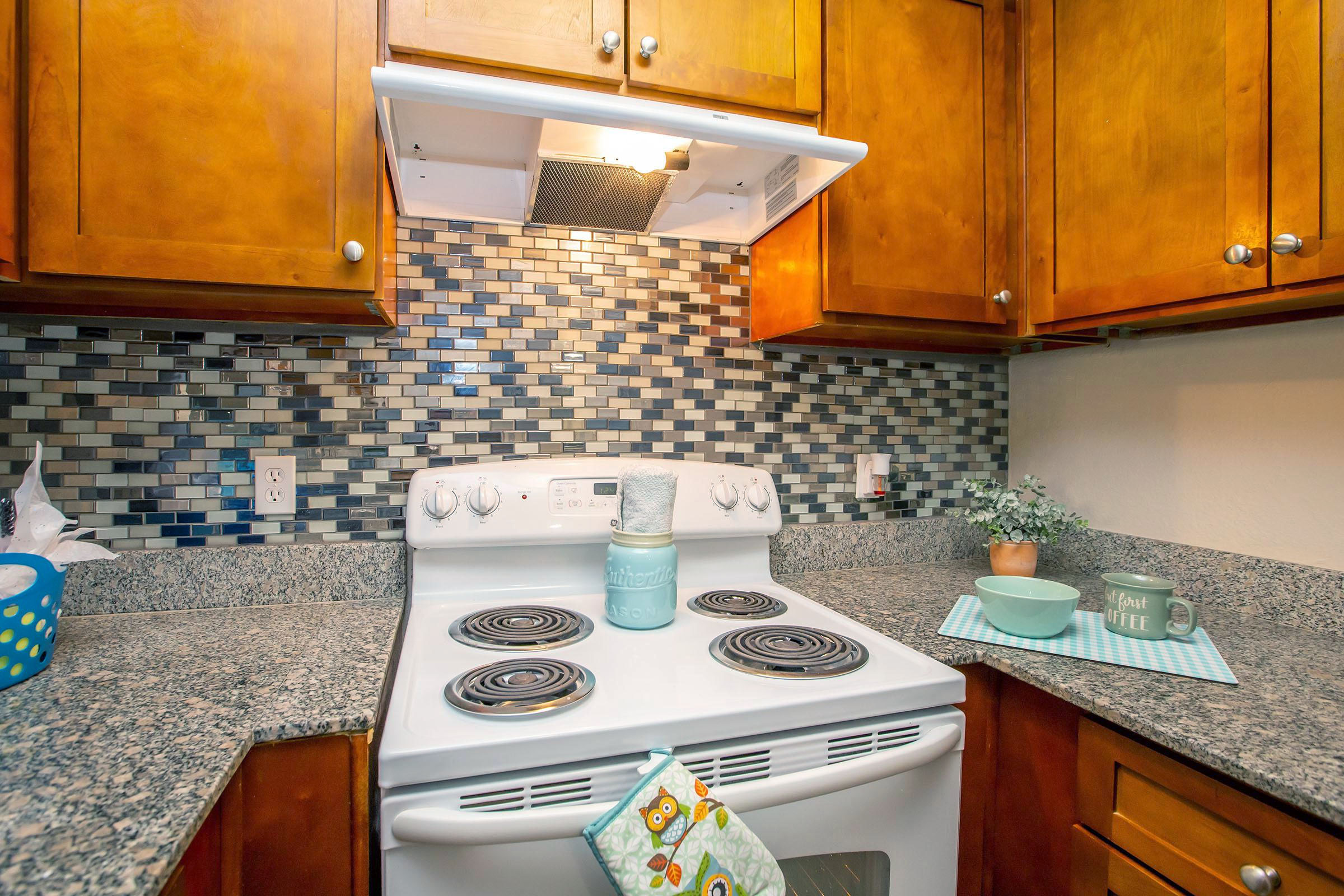 a stove top oven sitting inside of a kitchen counter