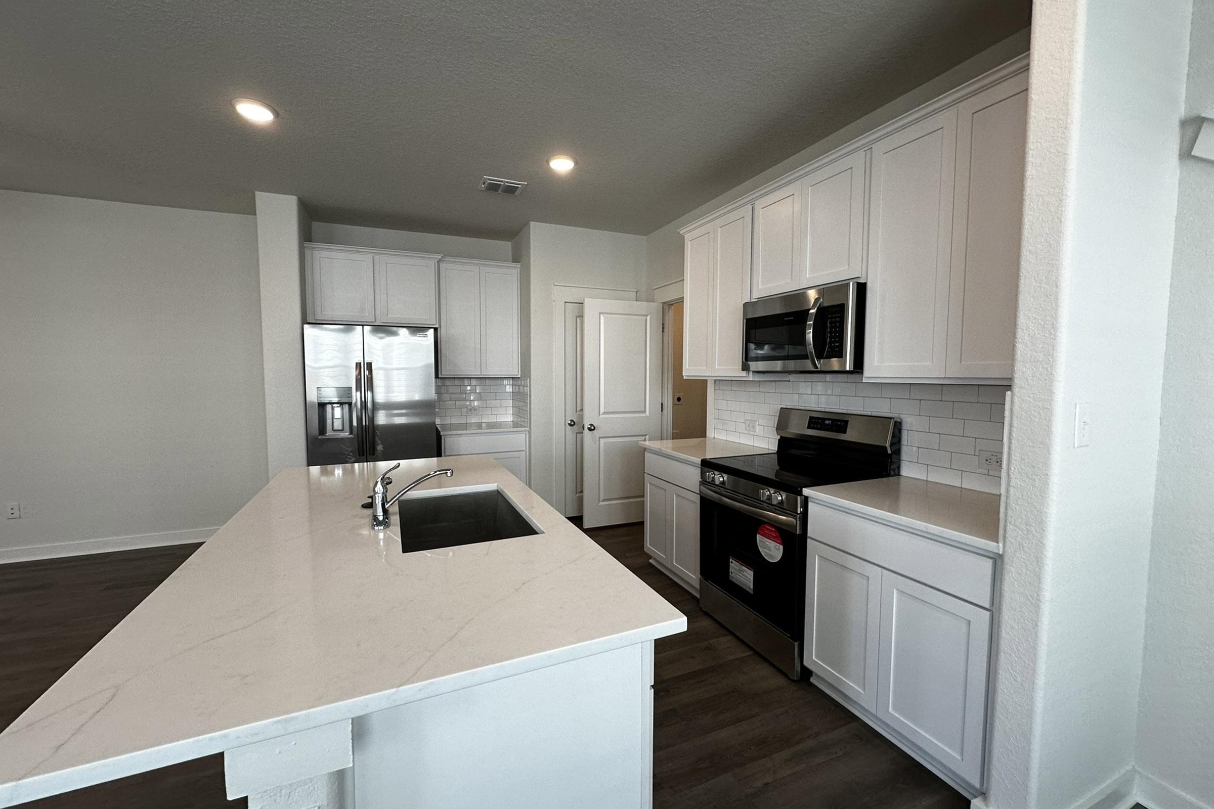 a modern kitchen with stainless steel appliances