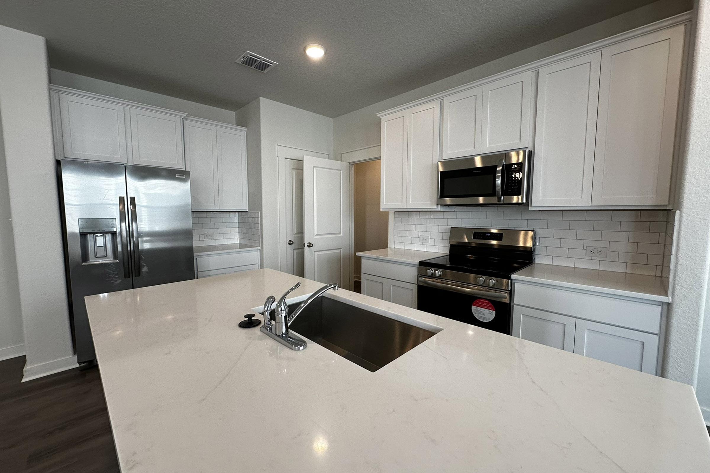 a kitchen with a sink and a refrigerator