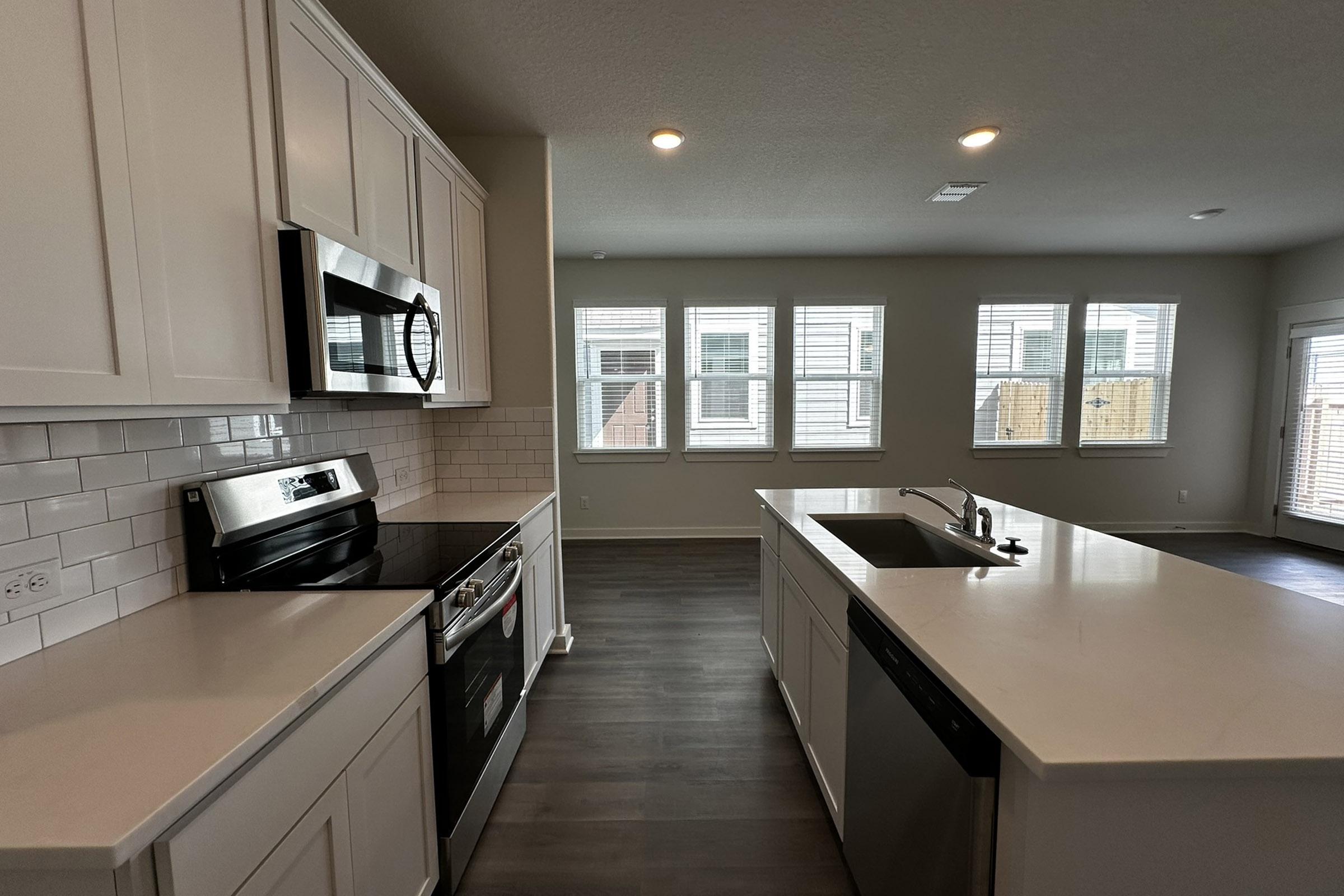 a kitchen with an island in the middle of a room