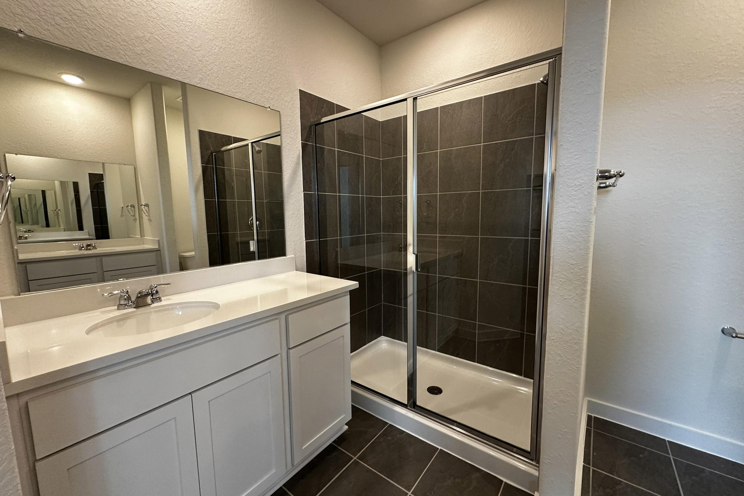 a kitchen with a sink and a shower