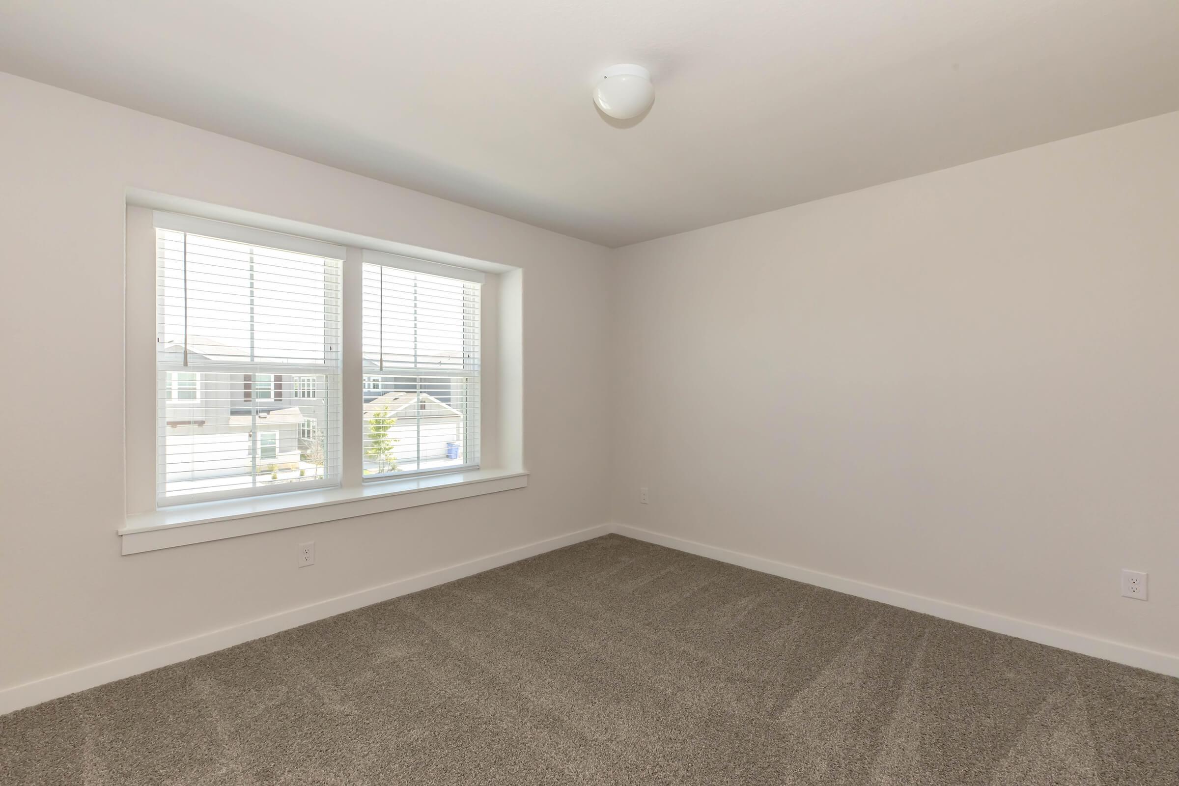 a bedroom with a large window