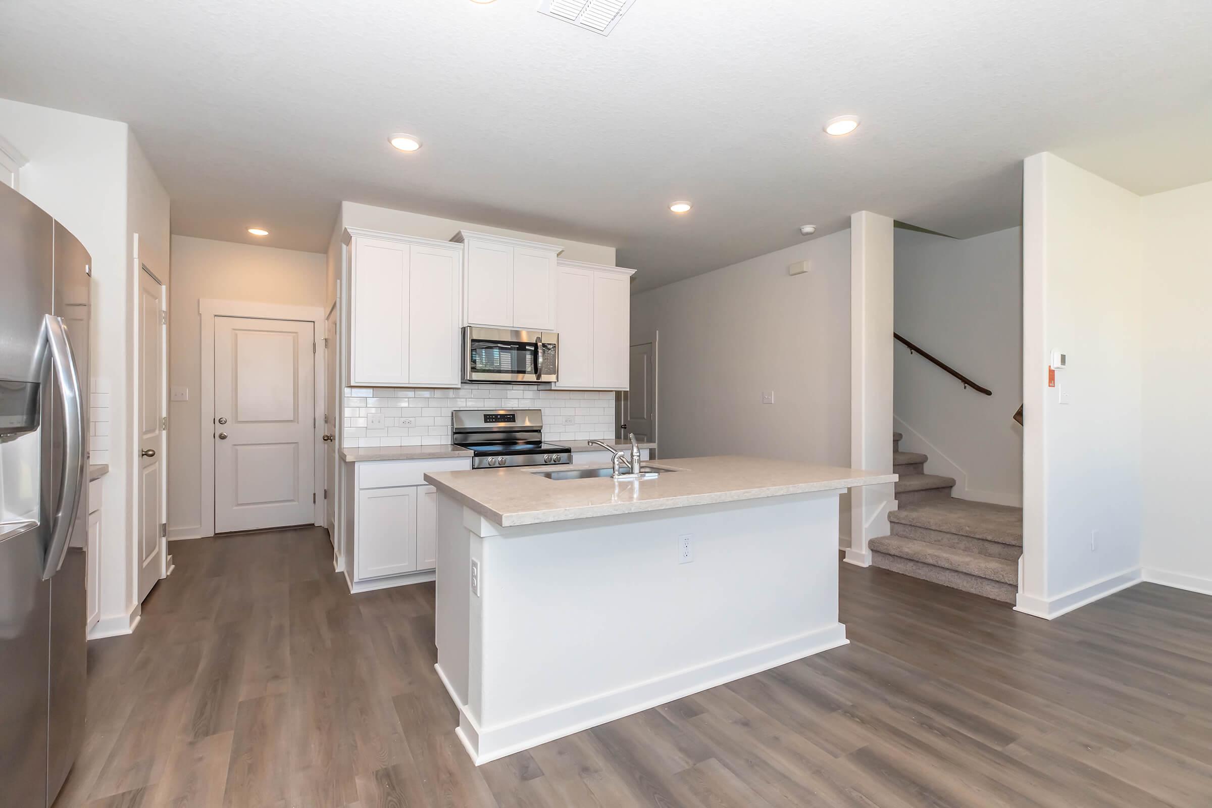 a kitchen with a wood floor