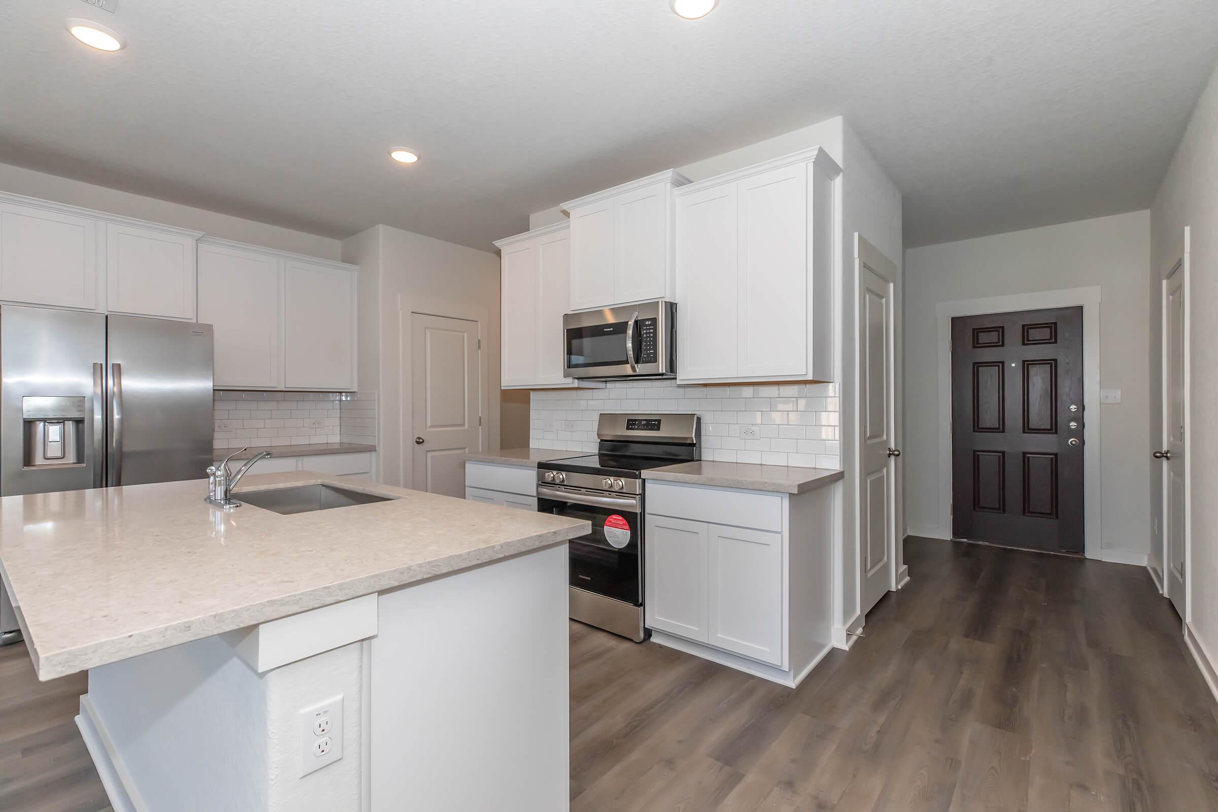 a modern kitchen with stainless steel appliances