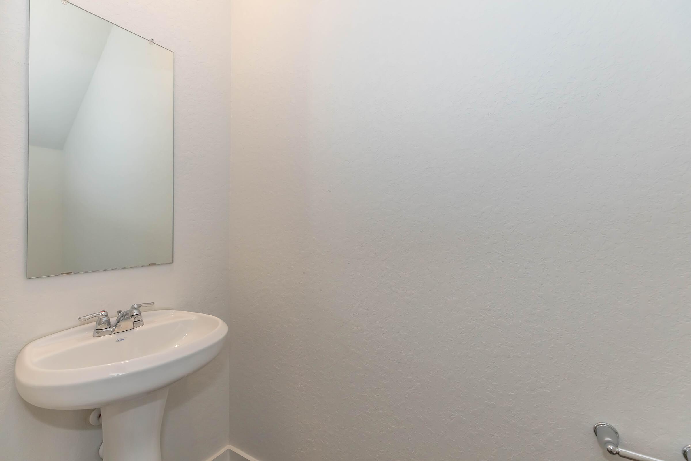 a close up of a sink and a mirror