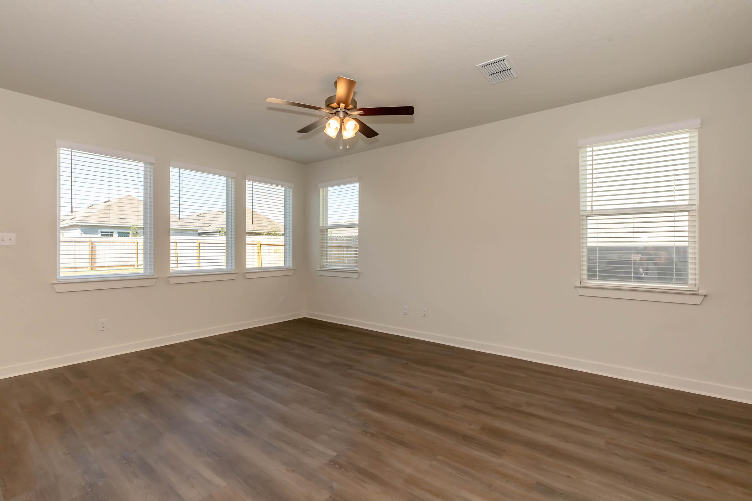 a room with wood floors and a large window