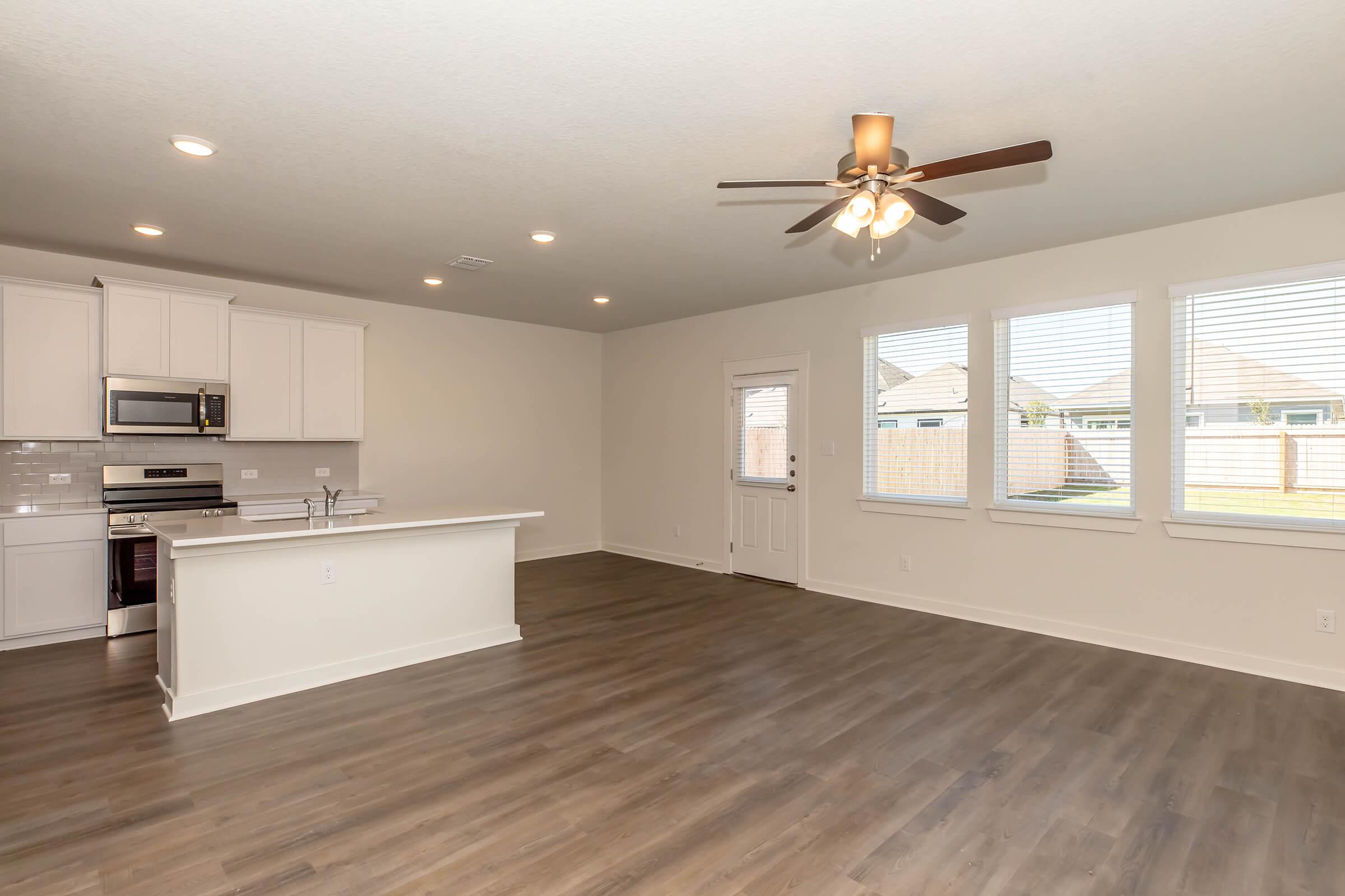 a large kitchen with an island in the middle of a room