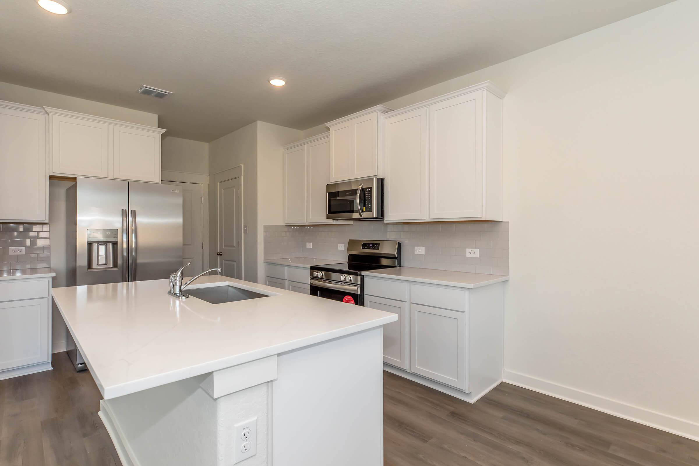 a large kitchen with stainless steel appliances