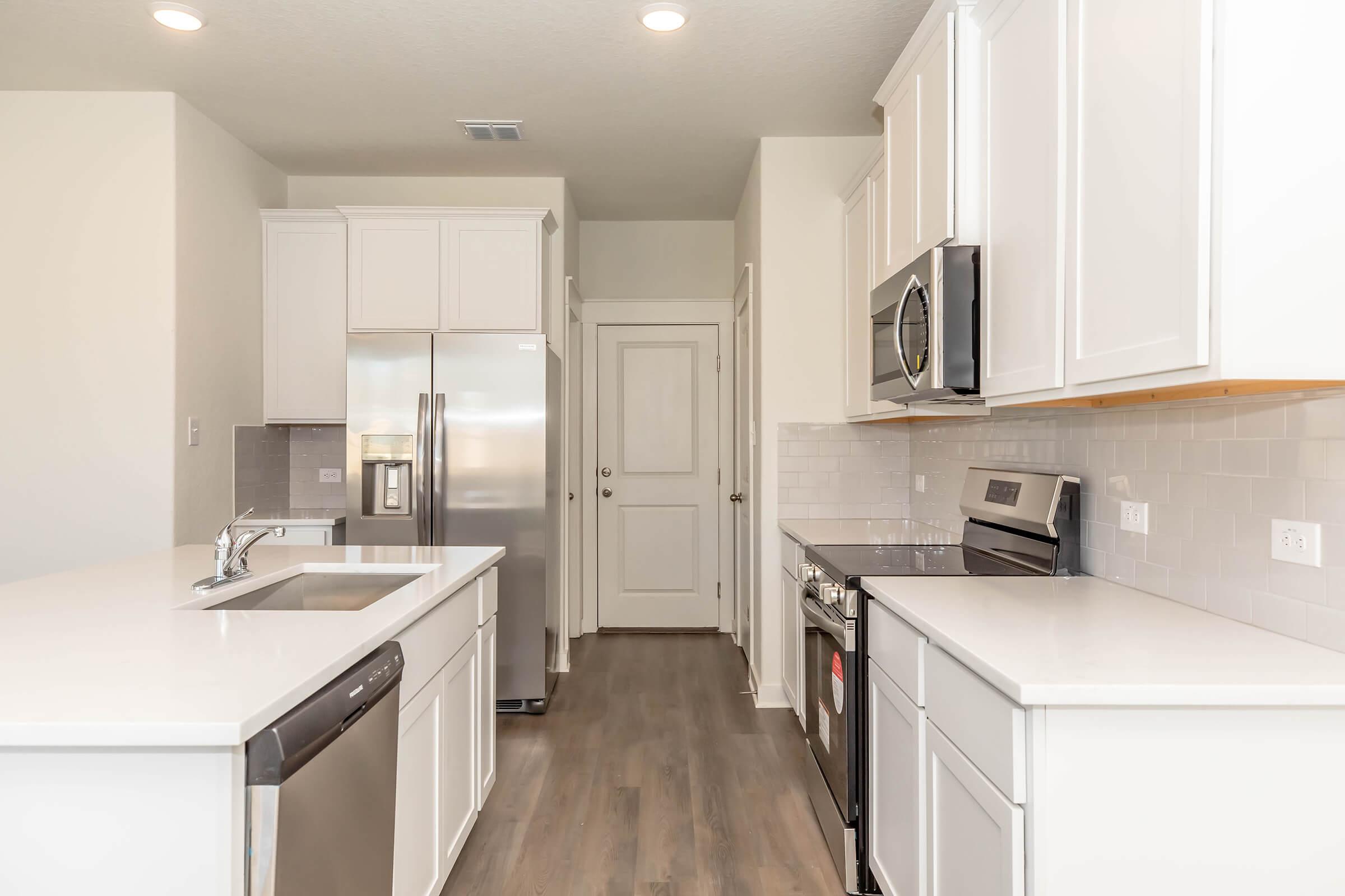 a kitchen with a sink and a refrigerator