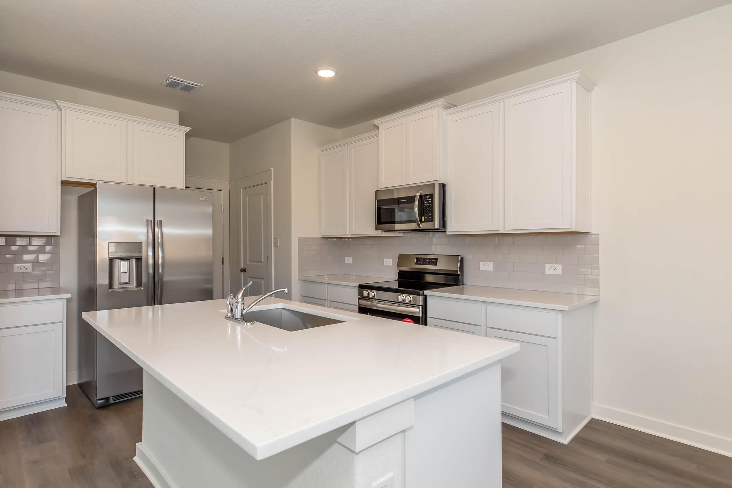 a kitchen with a sink and a refrigerator