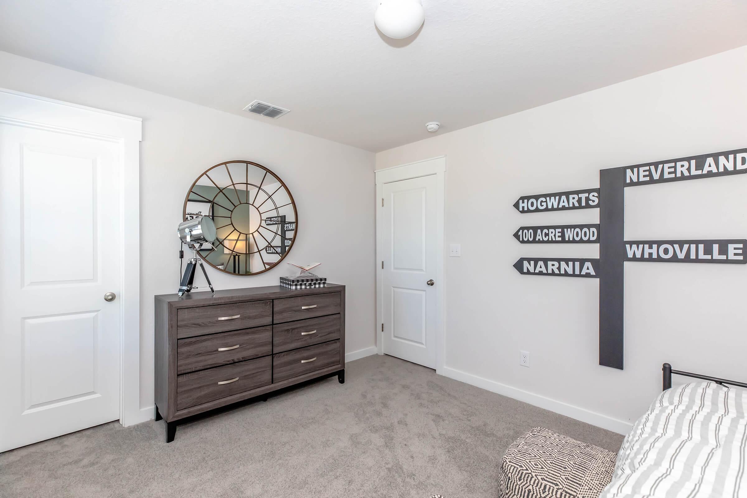 a bedroom with a ceiling fan in a room