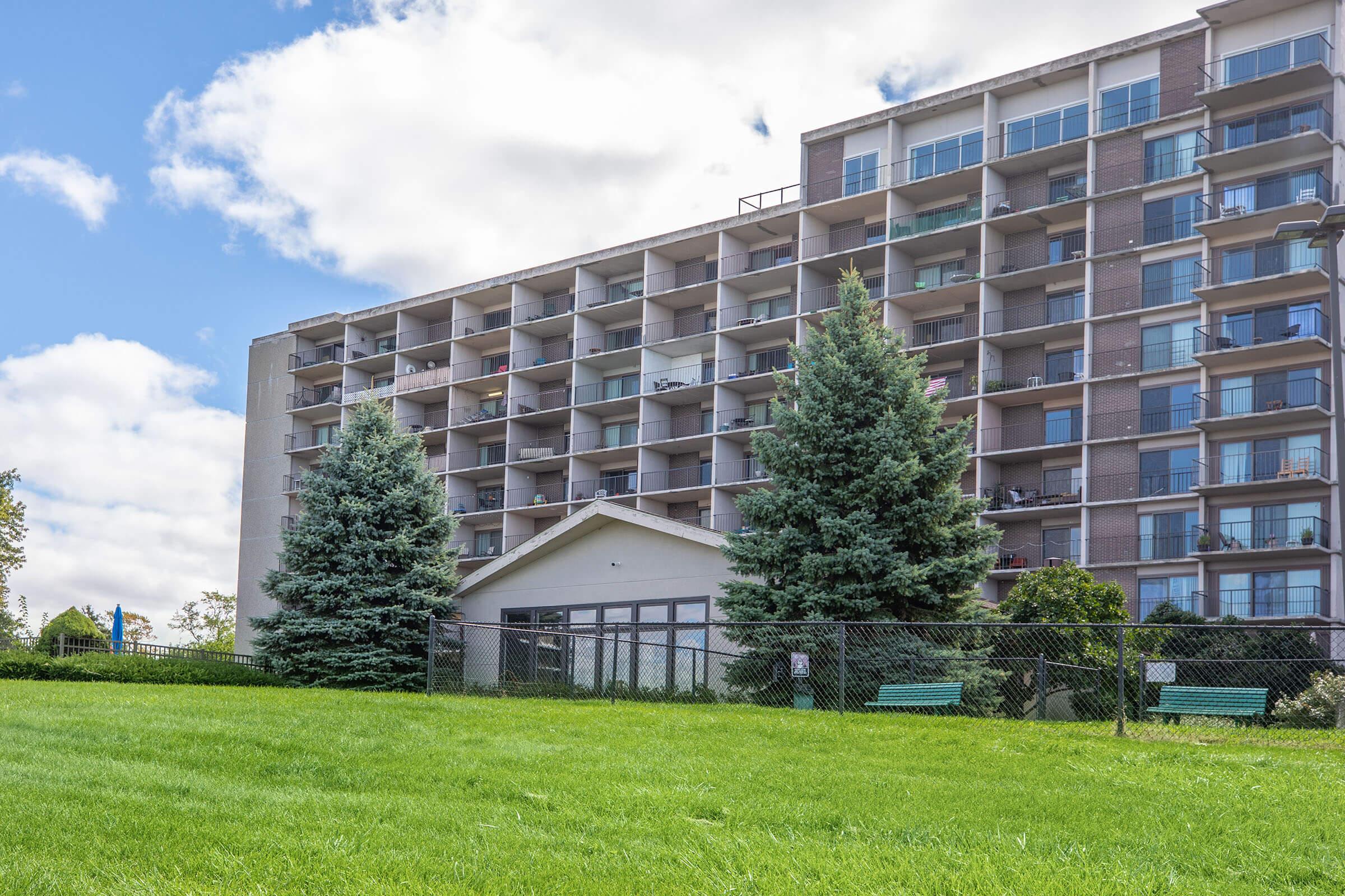 a large building with a grassy field