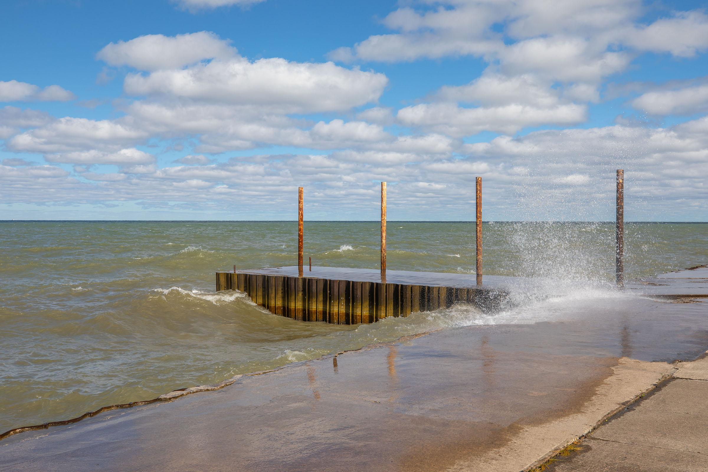 a sandy beach next to a body of water