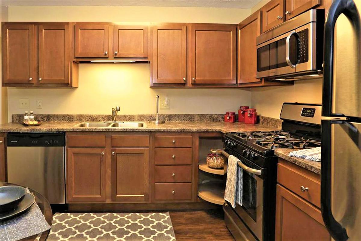 a kitchen with stainless steel appliances and wooden cabinets