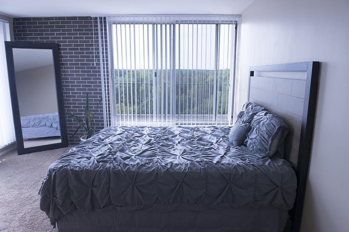 a bedroom with a bed and a window