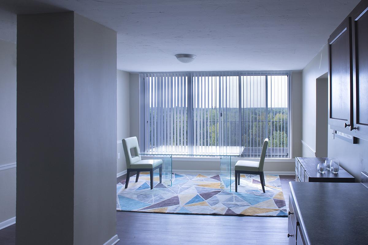 a living room filled with furniture and a large window